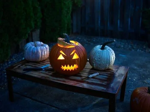 Jack O Lantern and Blue Pumpkins Lit Up at Night Wallpaper