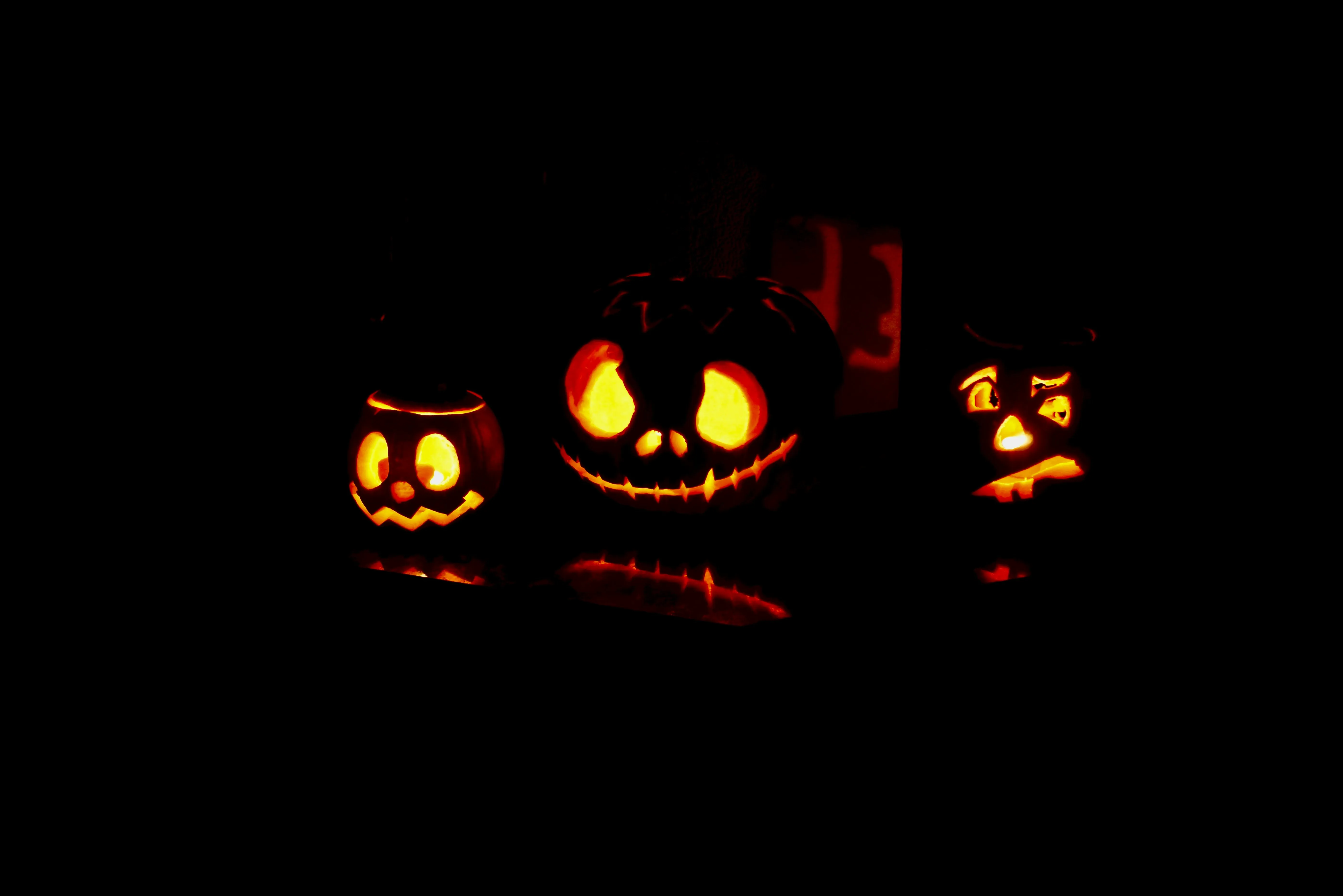 Jack O Lantern Trio Glowing in a Dark Spooky Background