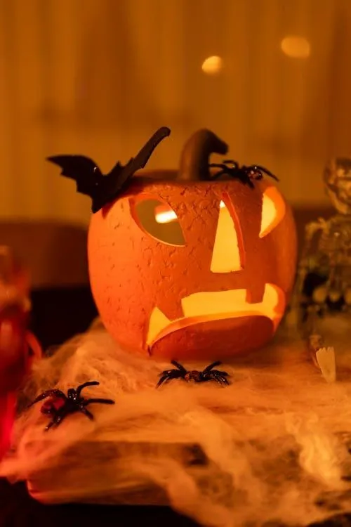 Jack O Lantern with Bat Decoration Glowing in Warm Light