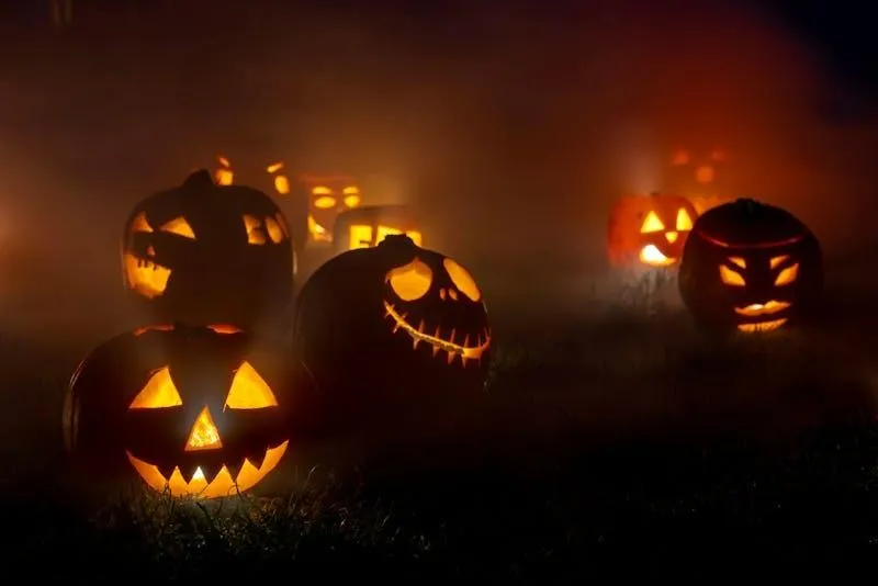 Jack O Lanterns Glowing Brightly in a Dark Room Wallpaper