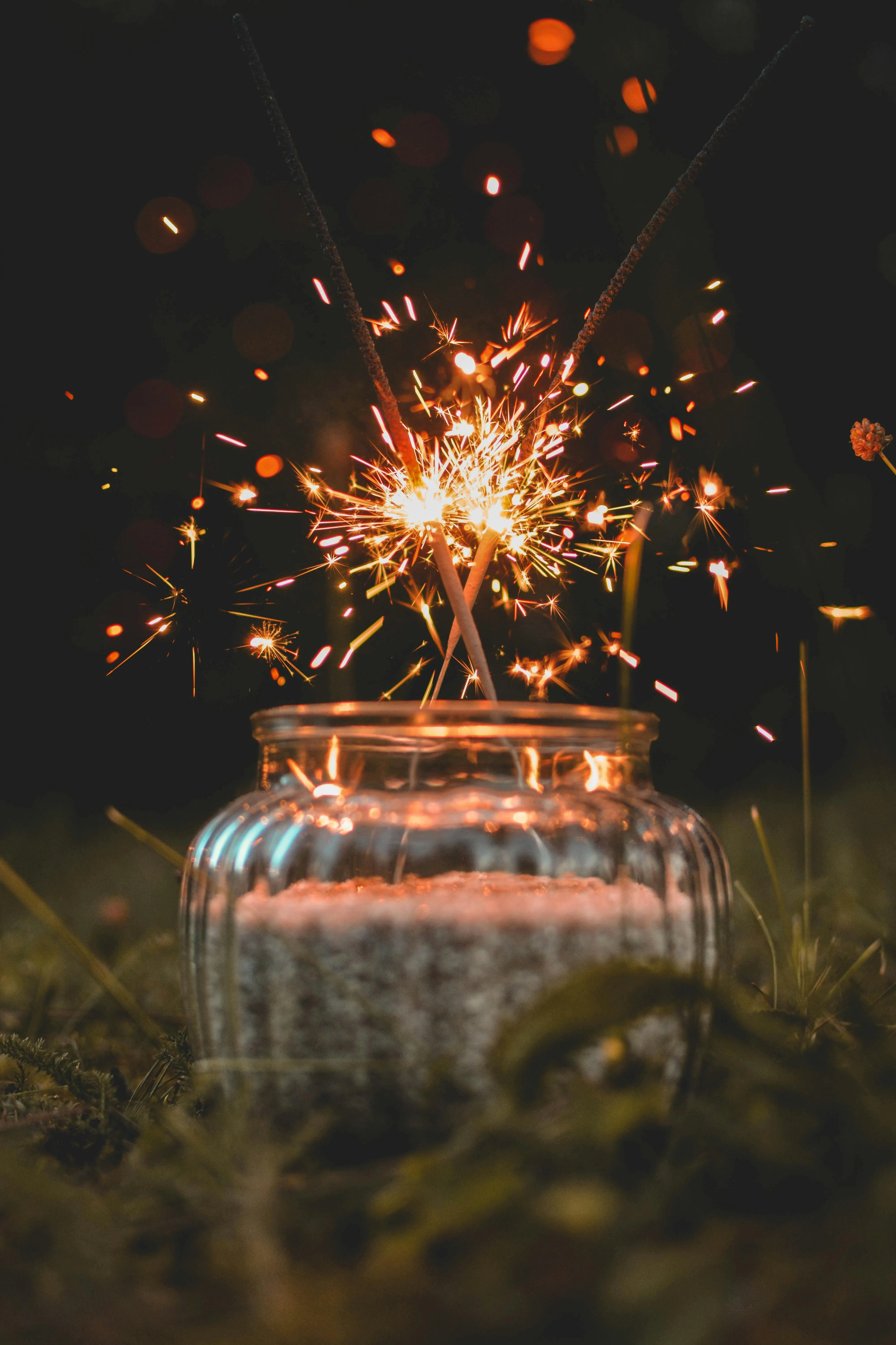 Jar surrounded by firework sparks in a dark setting HD