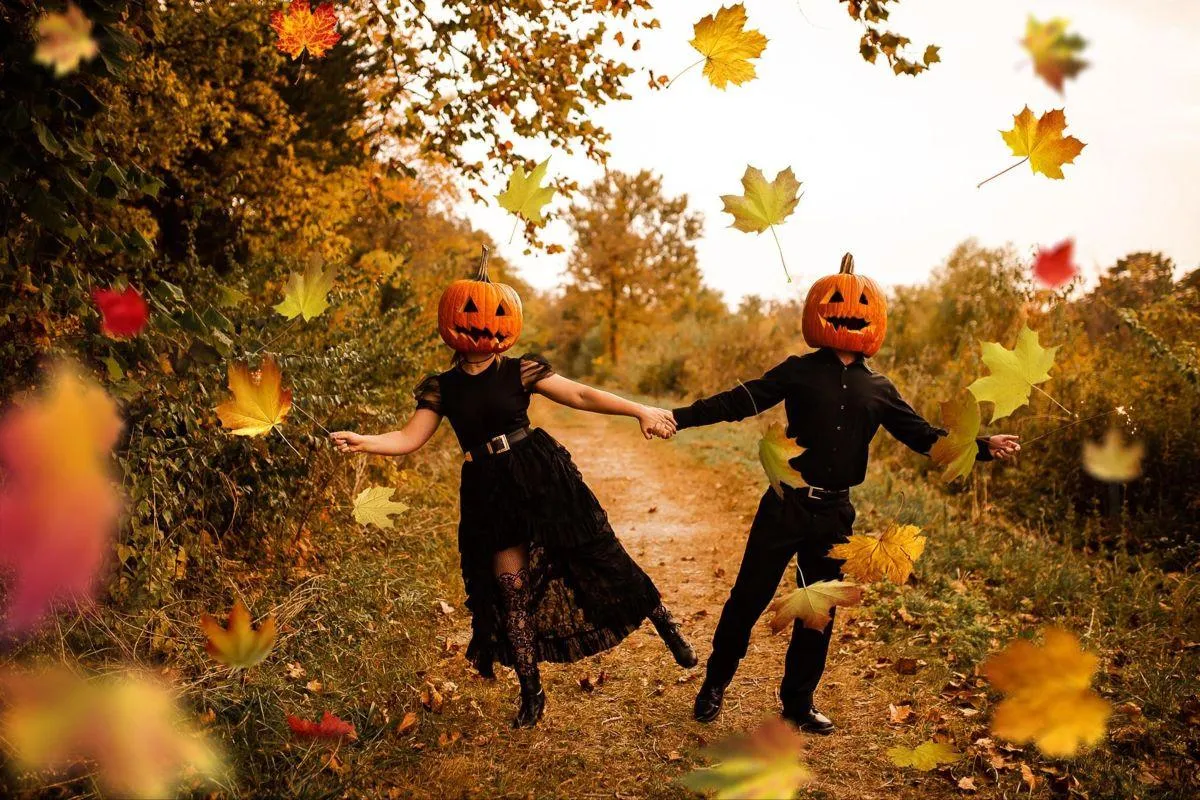 Joyful Halloween Festival Couple Jumping in Leaf Pile