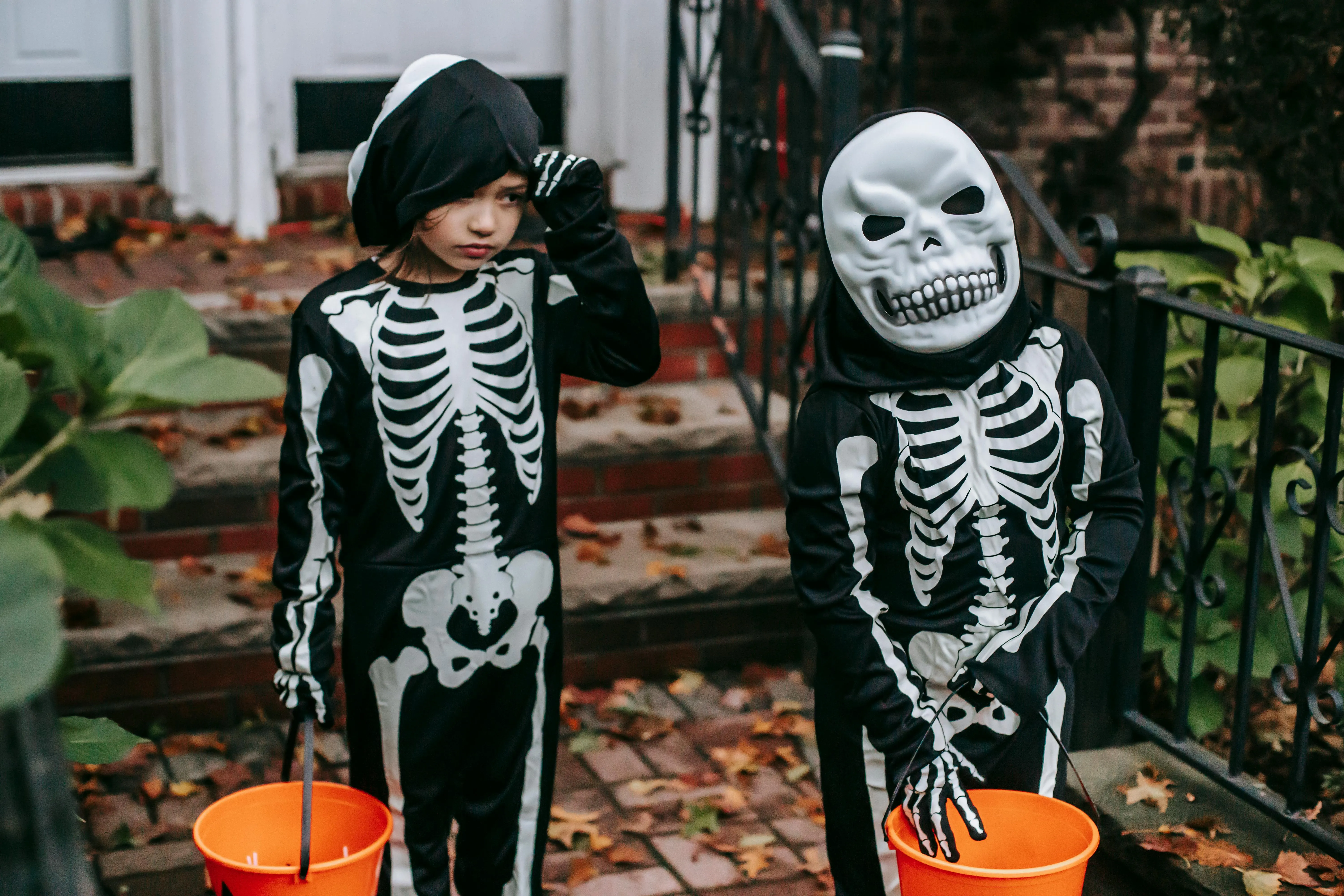 Kids Dressed as Skeletons Trick or Treating Outdoors