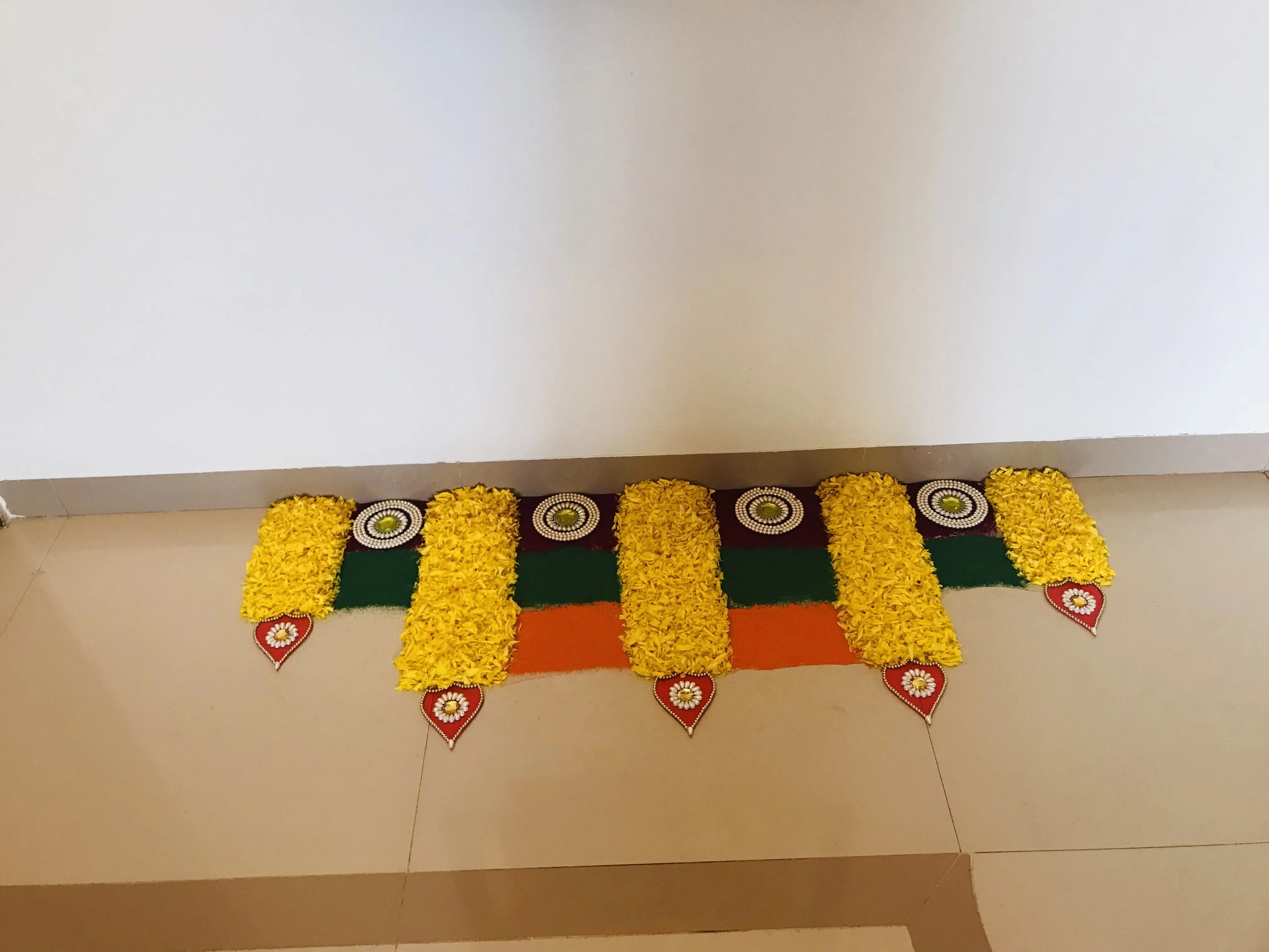 Linear pookolam design with Yellow Petals and stones HD