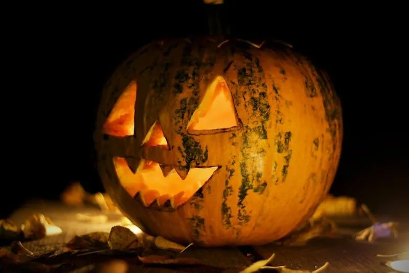 Lit Jack O Lantern with Happy Face on Dark Background