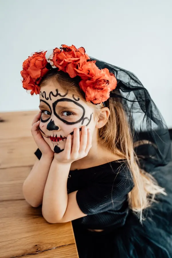 Little girl dressed in Day of the Dead costume with face paint
