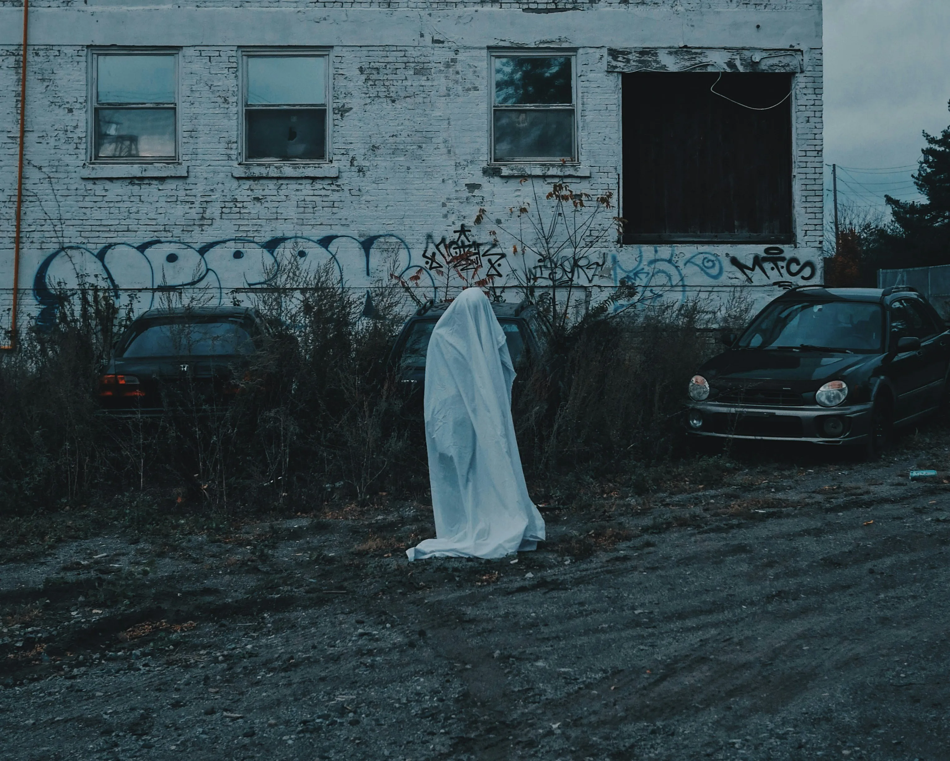 Lonely Ghost Costume in Abandoned Setting Wallpaper