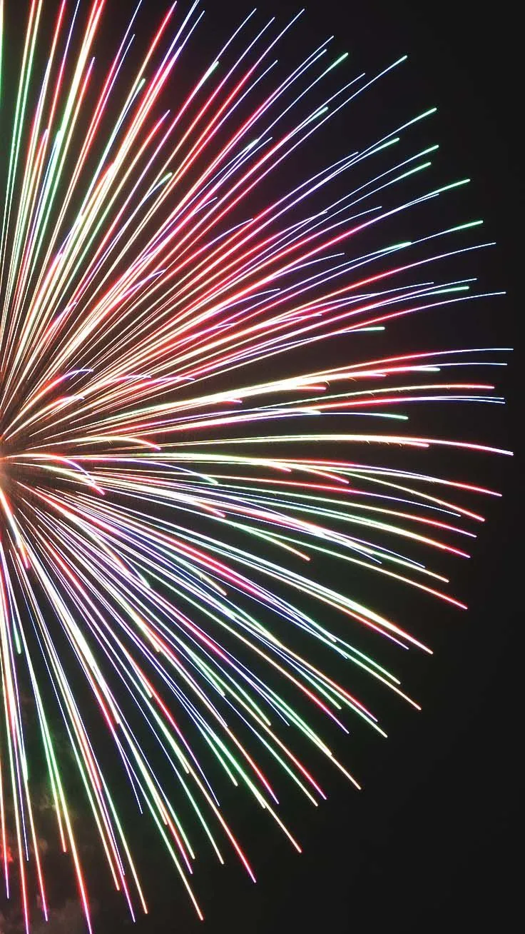 Long streaks of colorful fireworks creating a dramatic effect