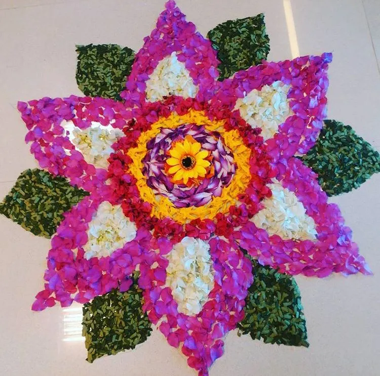 Lotus style Athapookolam with a yellow flower at the center