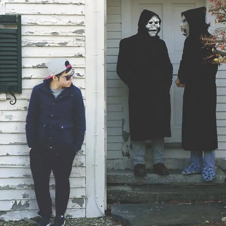 Man and Woman Wearing Black Costumes Standing near Door