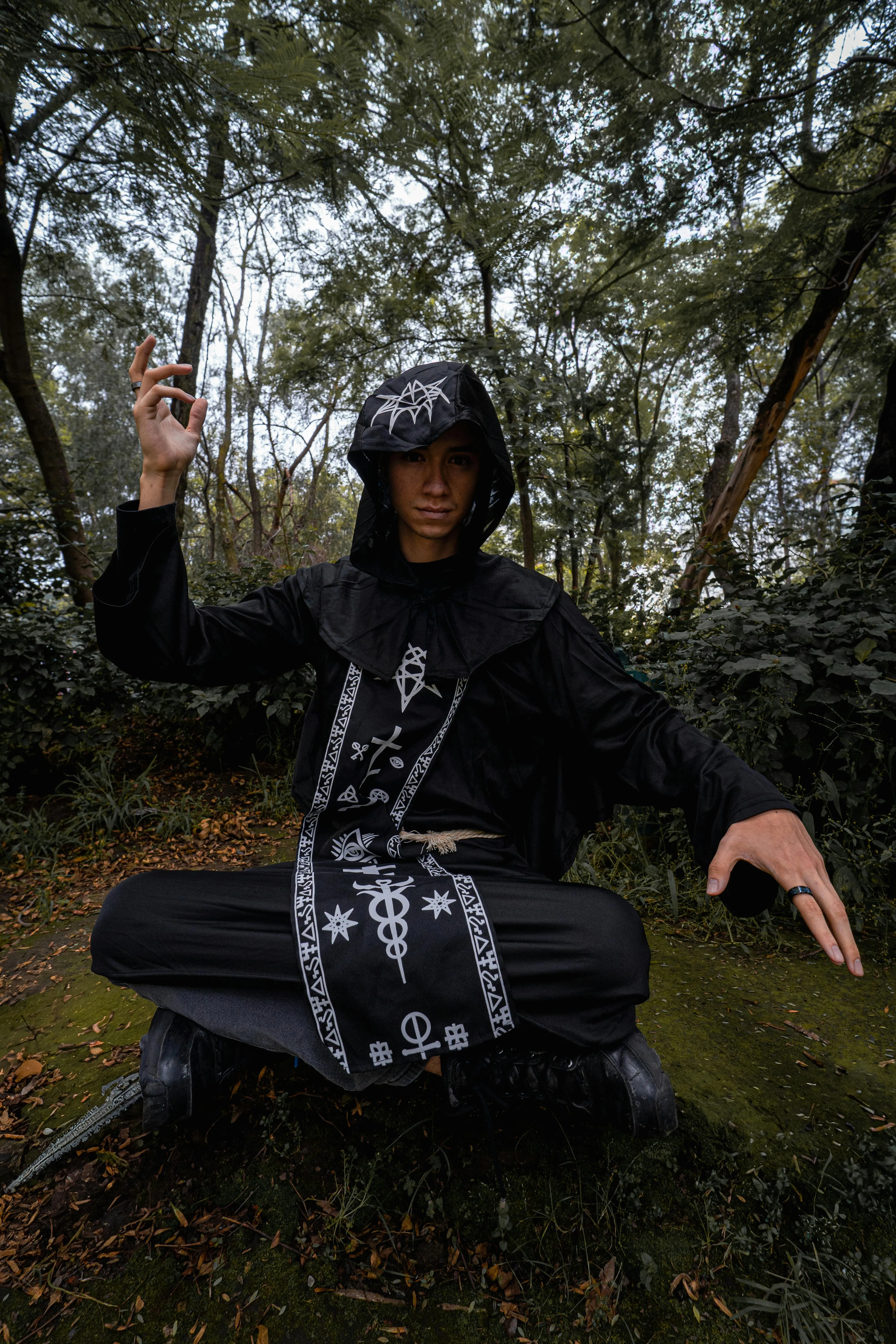 Man Dressed in Black Costume Posing in Forest Wallpaper