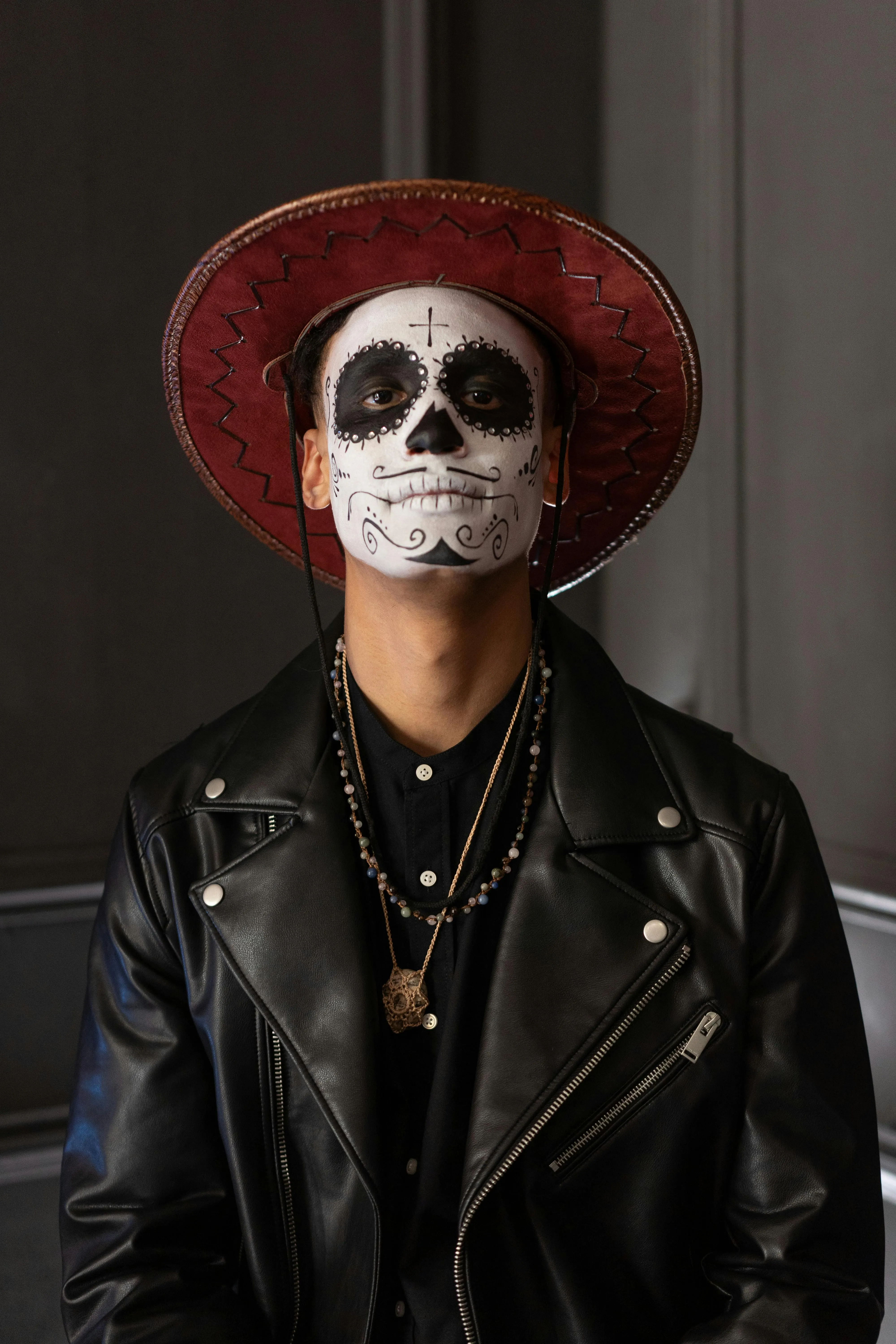 Man in Day of the Dead Costume with Red Hat free Wallpaper