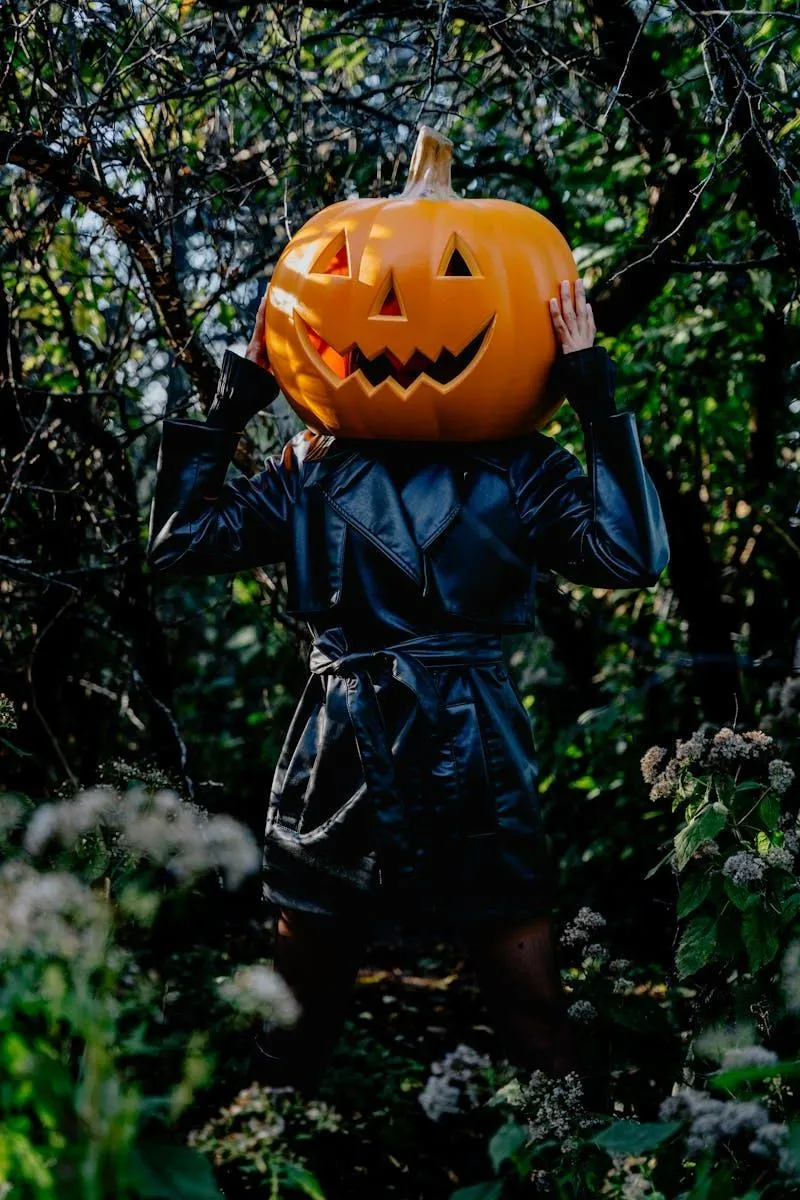 Man in Hoodie with Jack o Lantern Head Outdoors Wallpaper