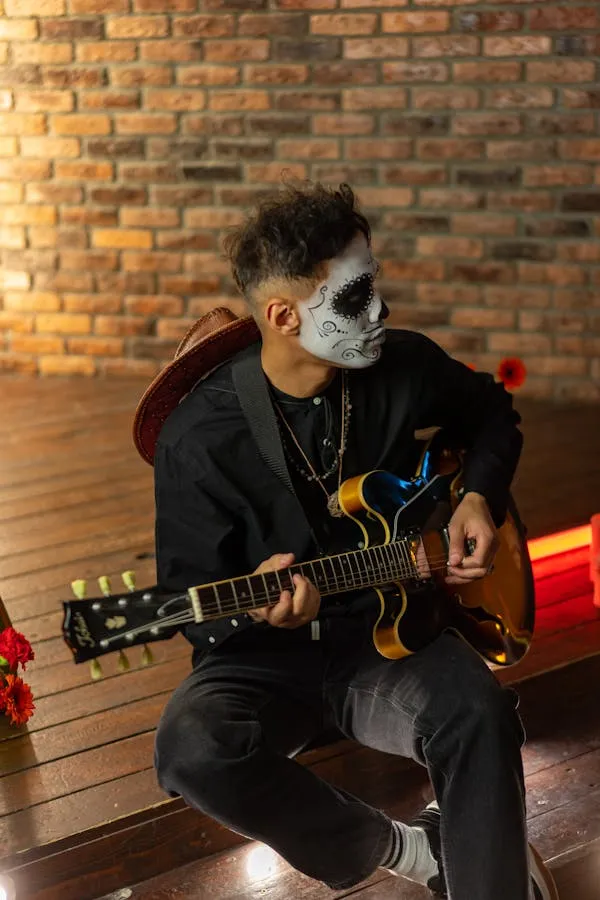 Man Playing Guitar in Halloween Themed Room with Lights