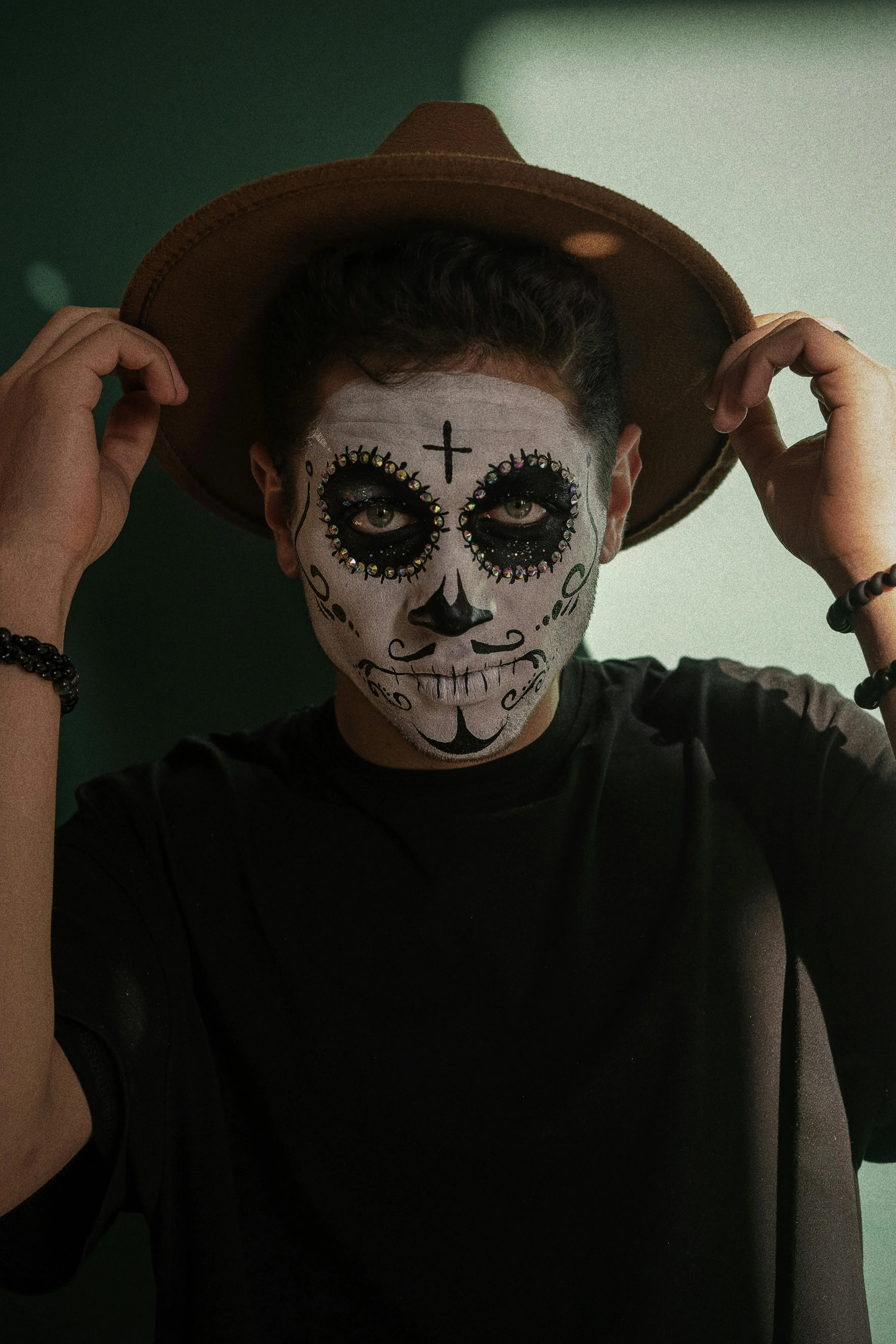 Man Wearing Hat and Skull Face Paint in Shadow Light