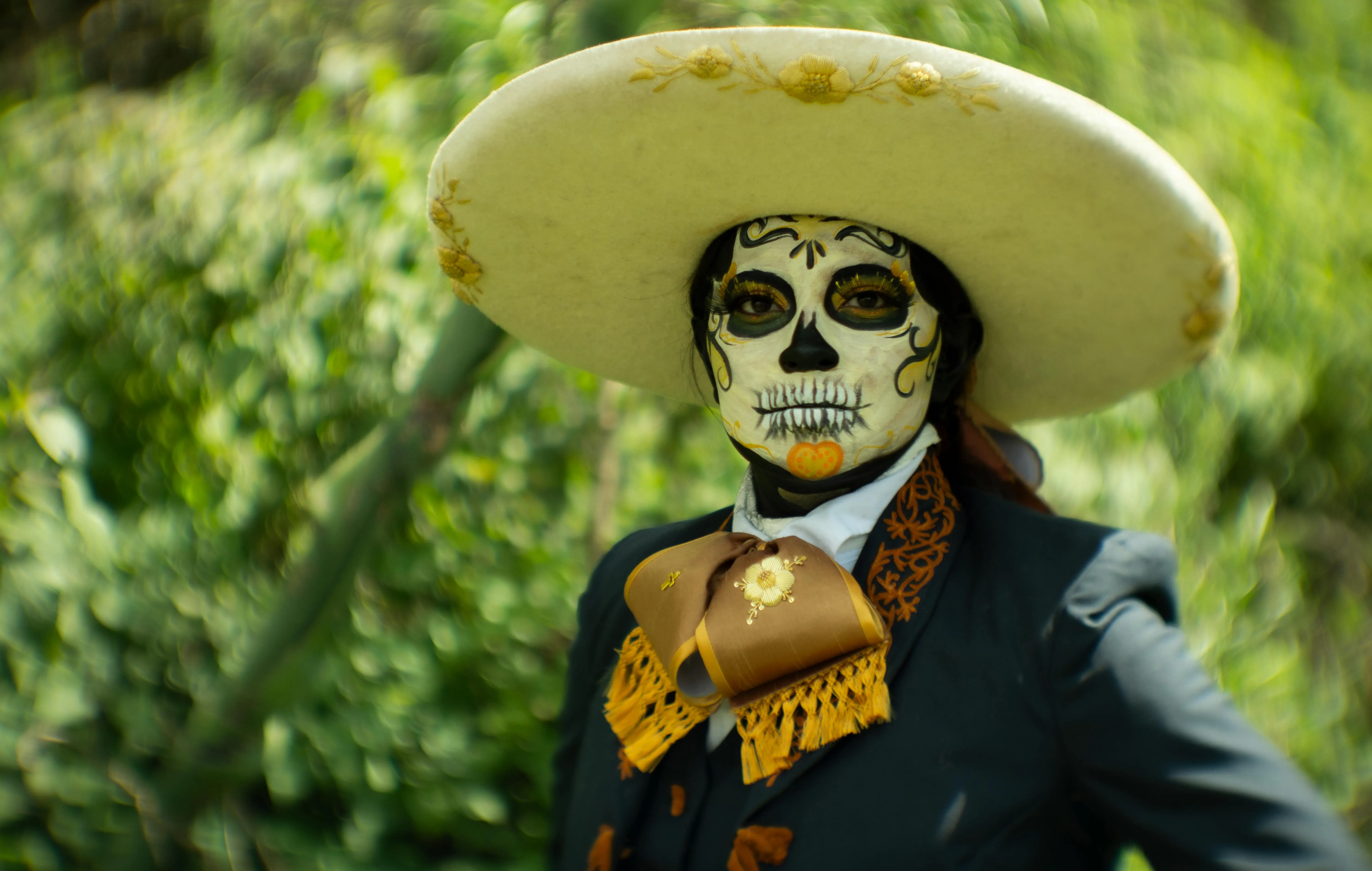 Man Wearing Large Hat and Skeleton Makeup Wallpaper