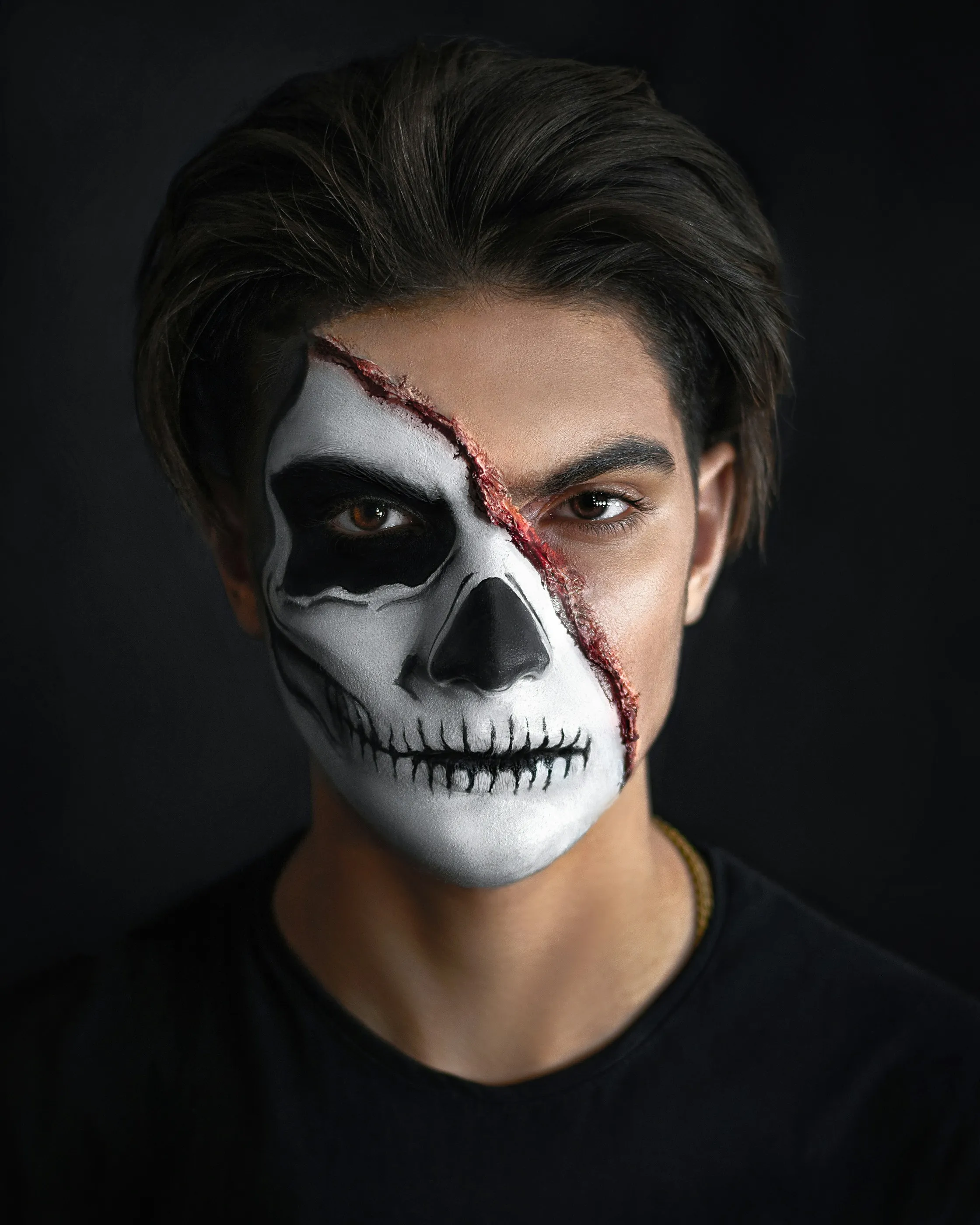 Man with Half Skull Face Paint on Black Background HD