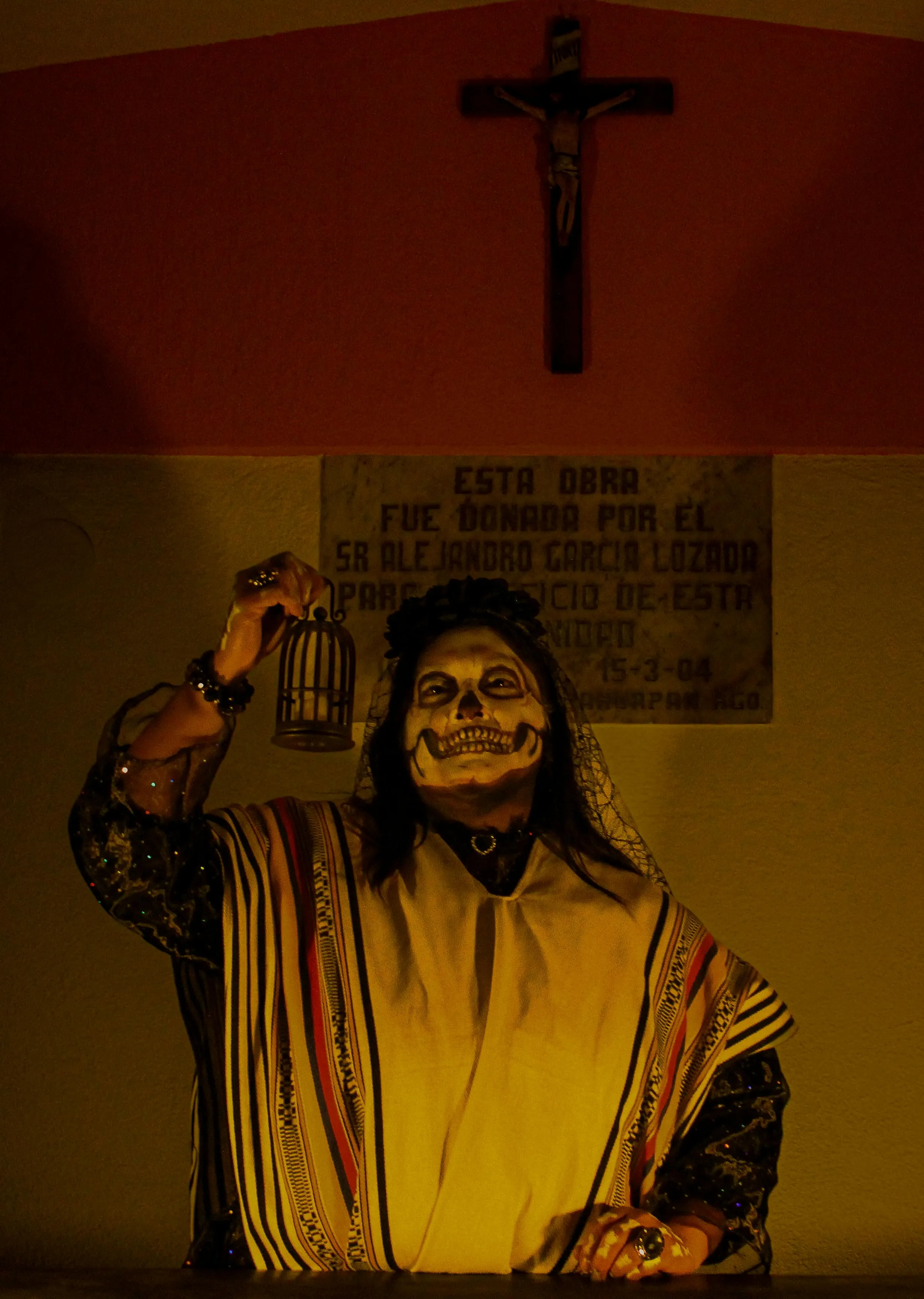 Man with Halloween Face Paint Holding a Candle Indoors