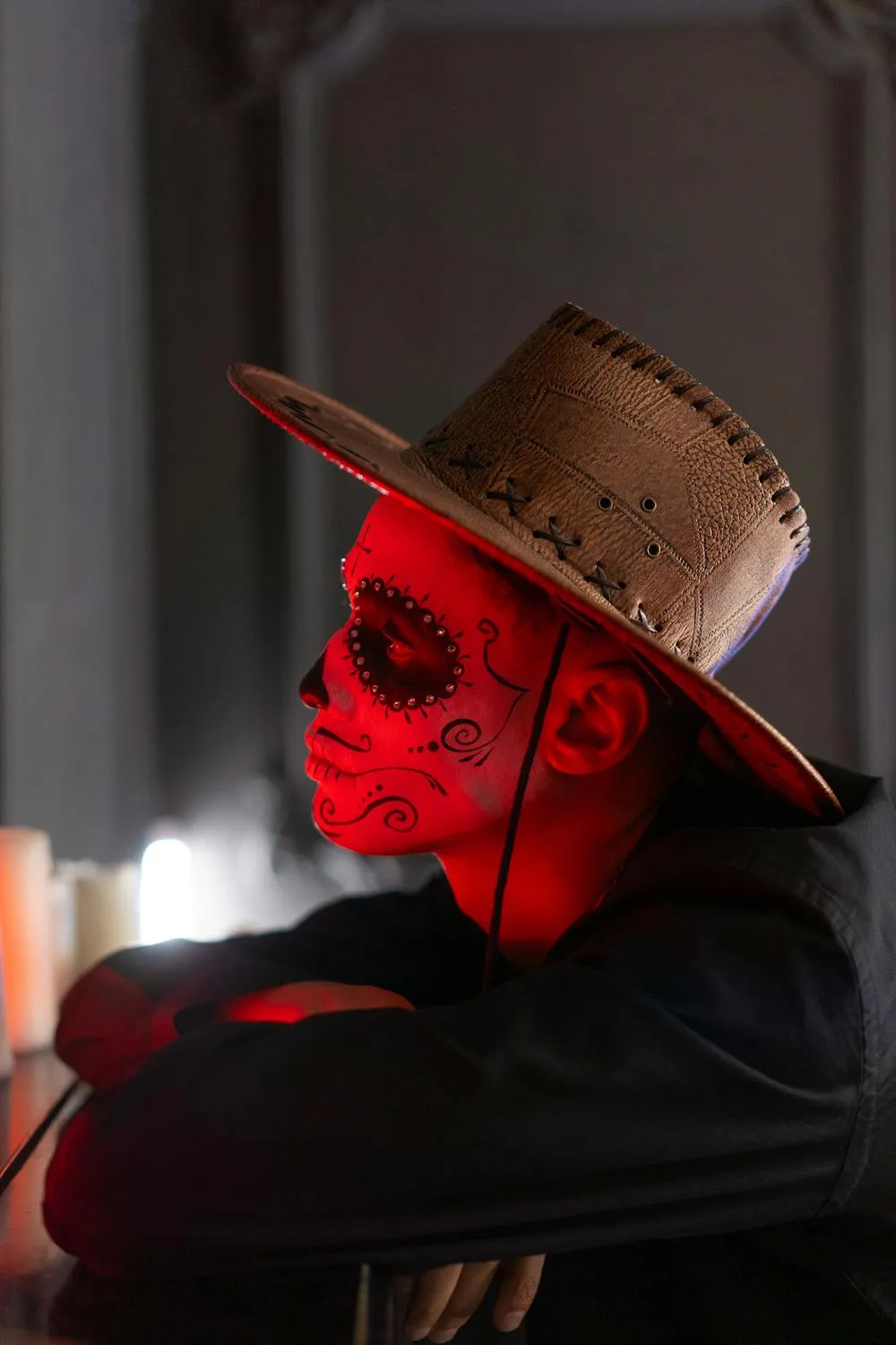 Man with Red Face Paint and Cowboy Hat Posing Wallpaper