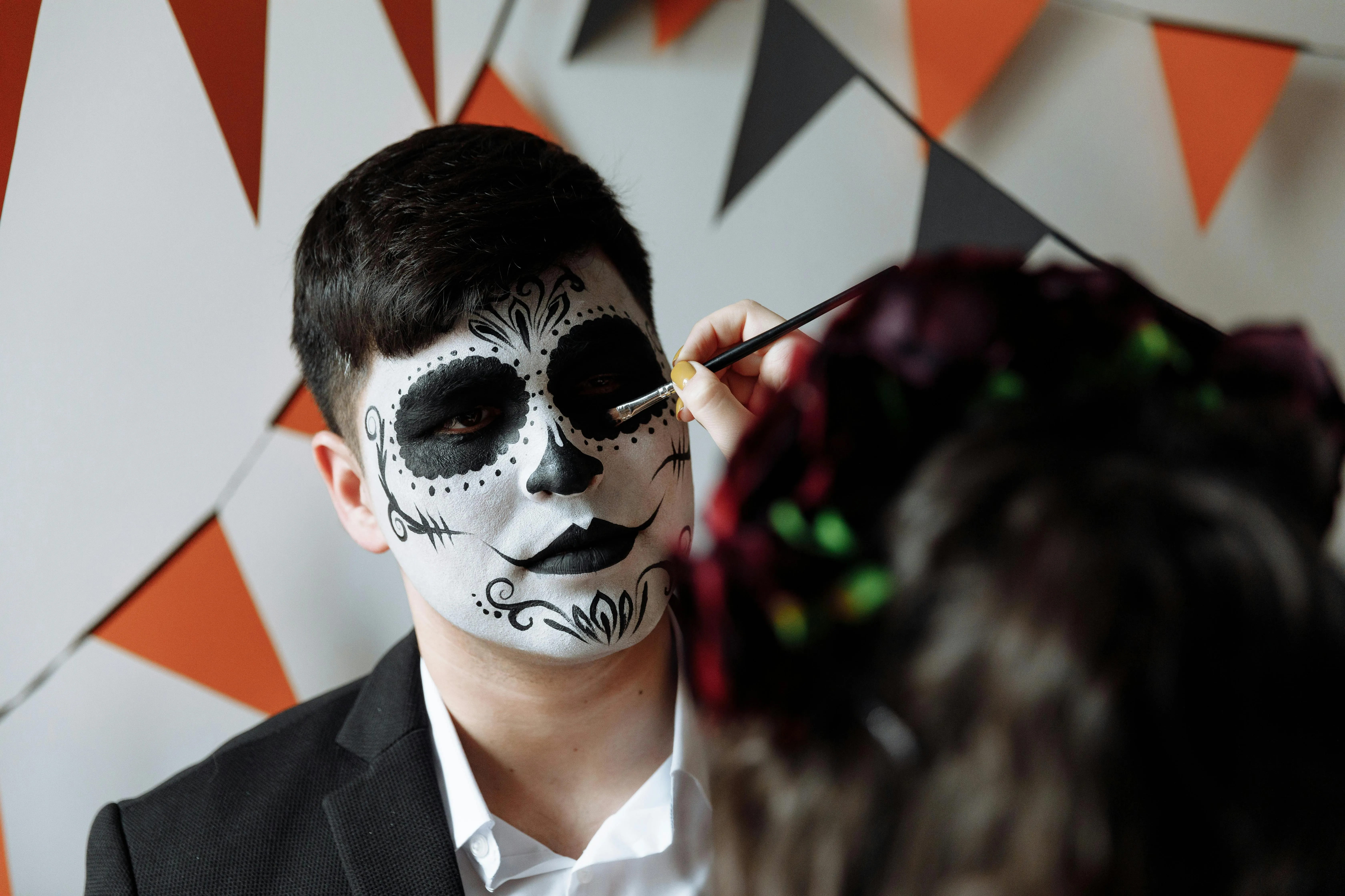 Man with Skeleton Face Paint at Halloween Party Wallpaper