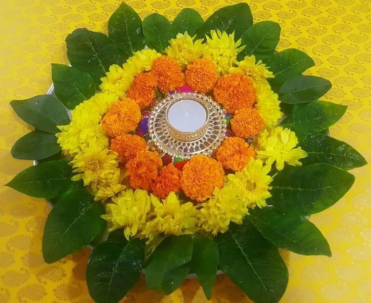 Marigold Flower Rangoli with Leaves free Wallpaper image