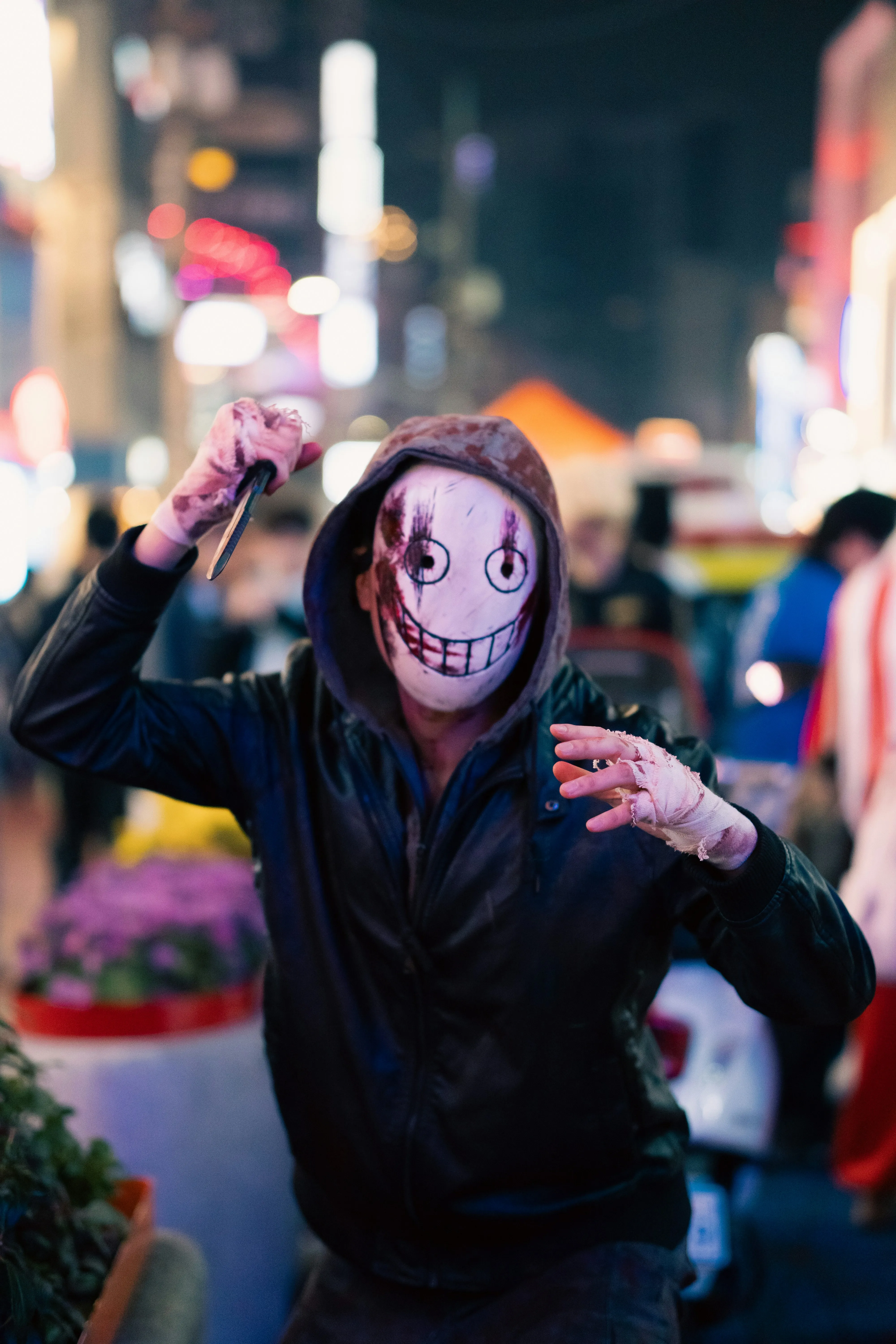 Masked Attendee at Halloween Festival with blur Backdrop
