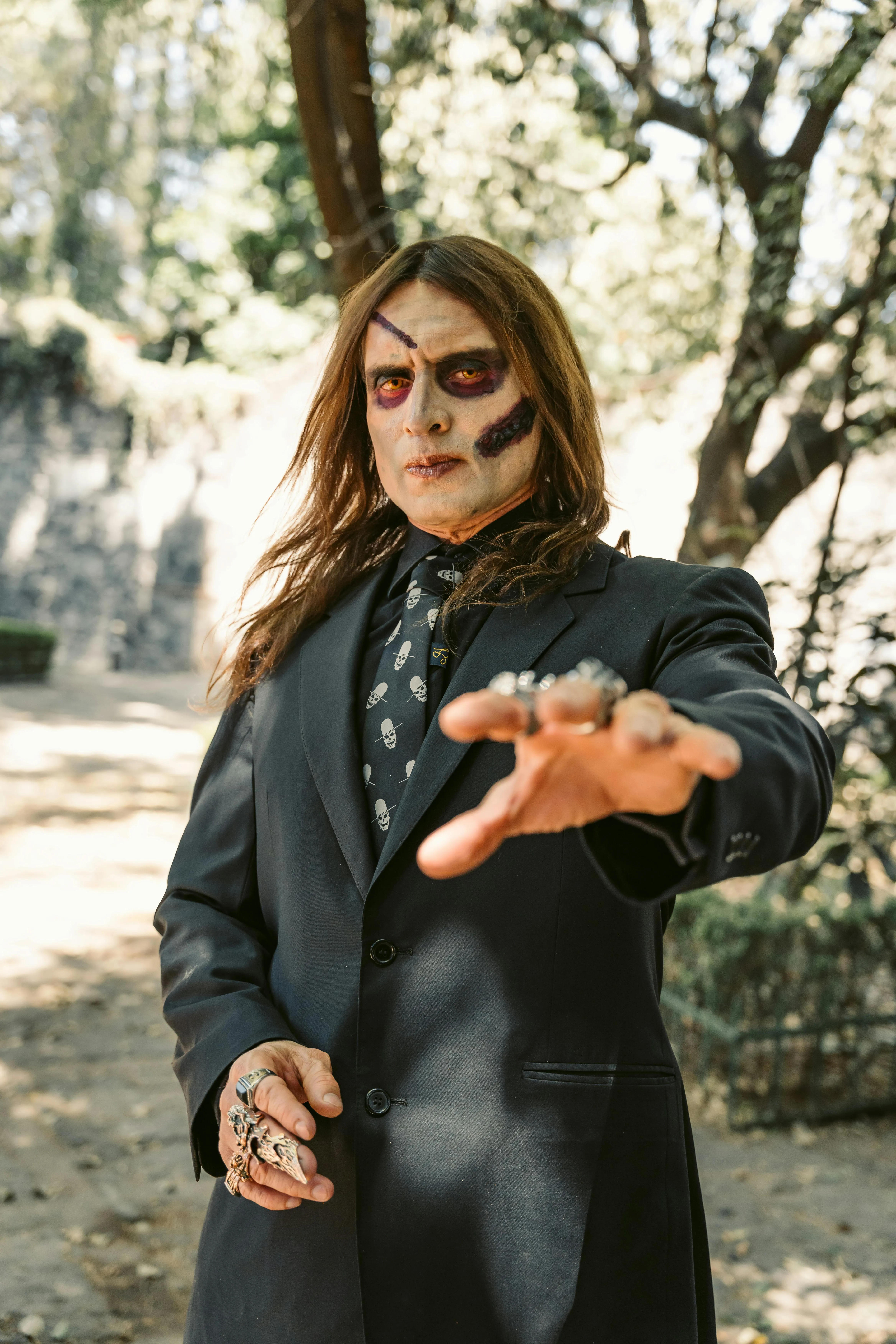 Men in Black Costume Posing Outdoors at Halloween image