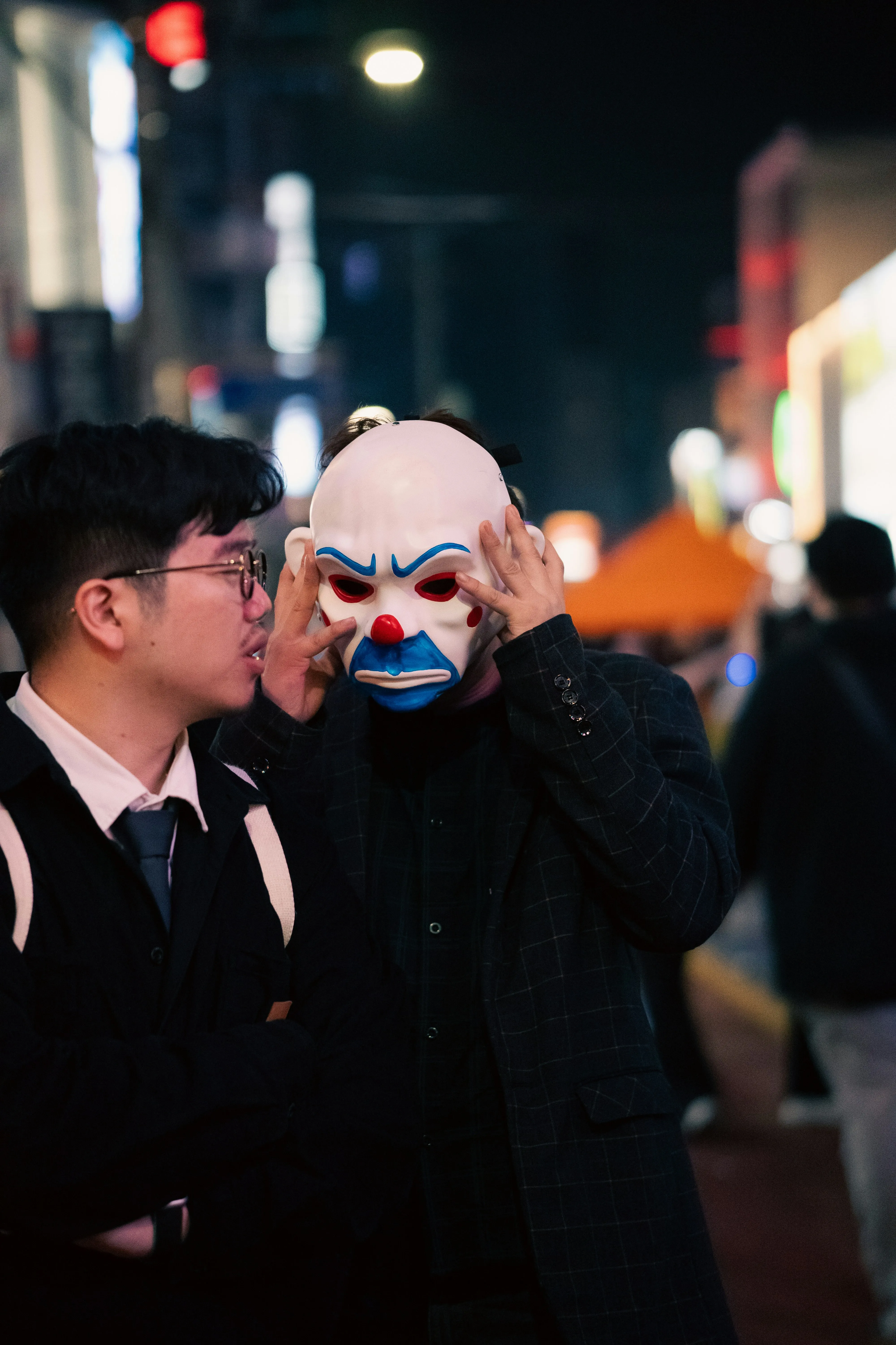 Men in Business Attire and Creepy Clown Mask at Night