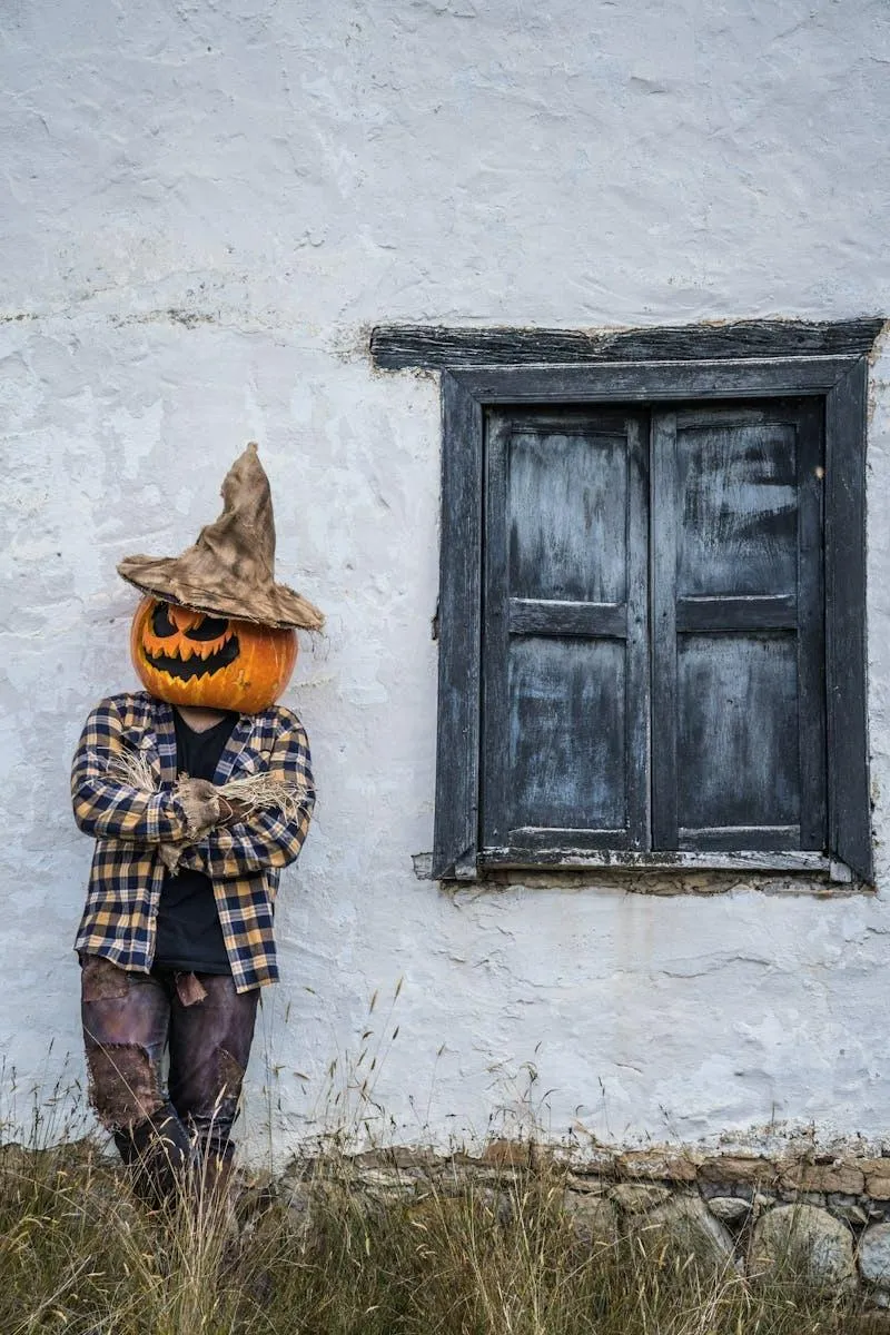 Men with Scarecrow Pumpkin Head near Old House Wallpaper
