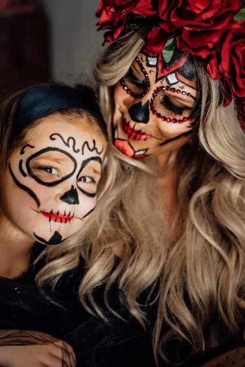 Mom and daughter in creative Halloween skull makeup image
