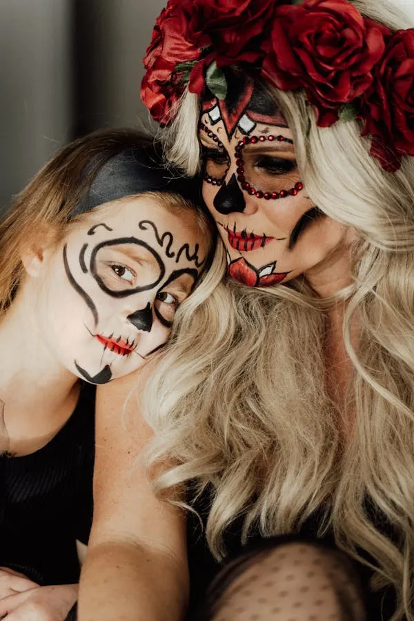 Mother and Kid in Halloween Skeleton Makeup at Home image