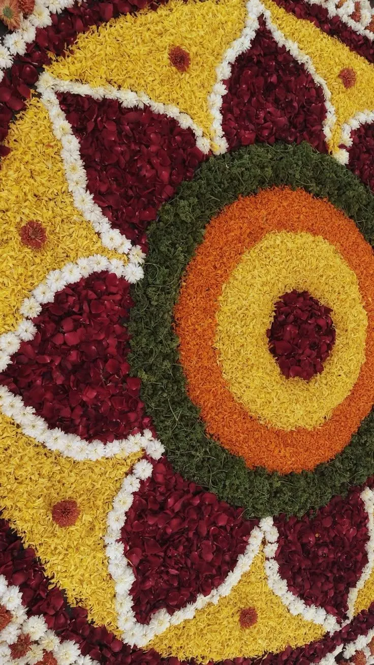 Multicolour circular floral rangoli design with rose petals