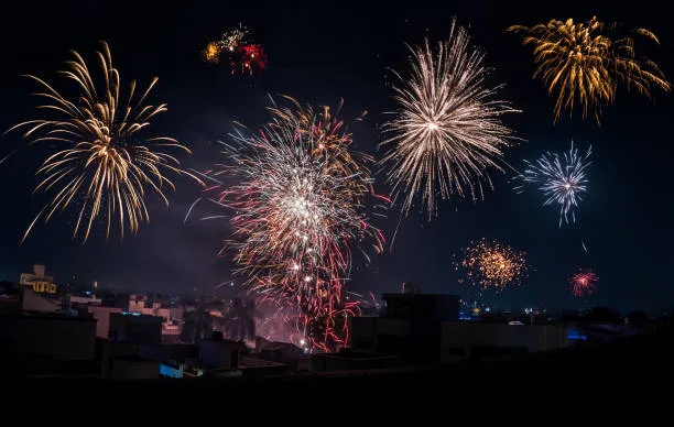 Nighttime cityscape lit up by expert fireworks display