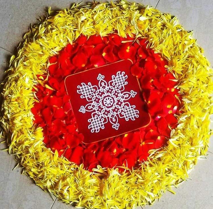 Onam pookolam circular design with yellow and red petals