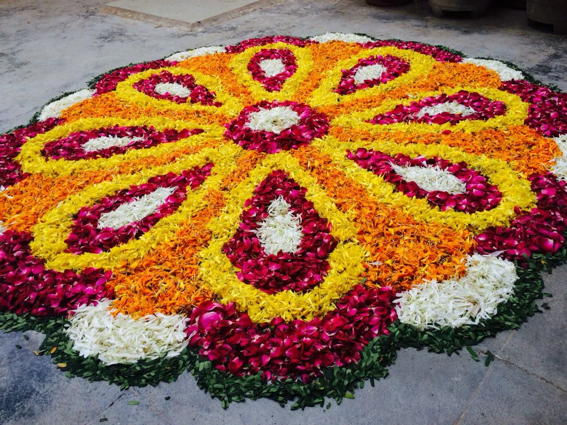 Onam pookolam design with colourful petals and patterns
