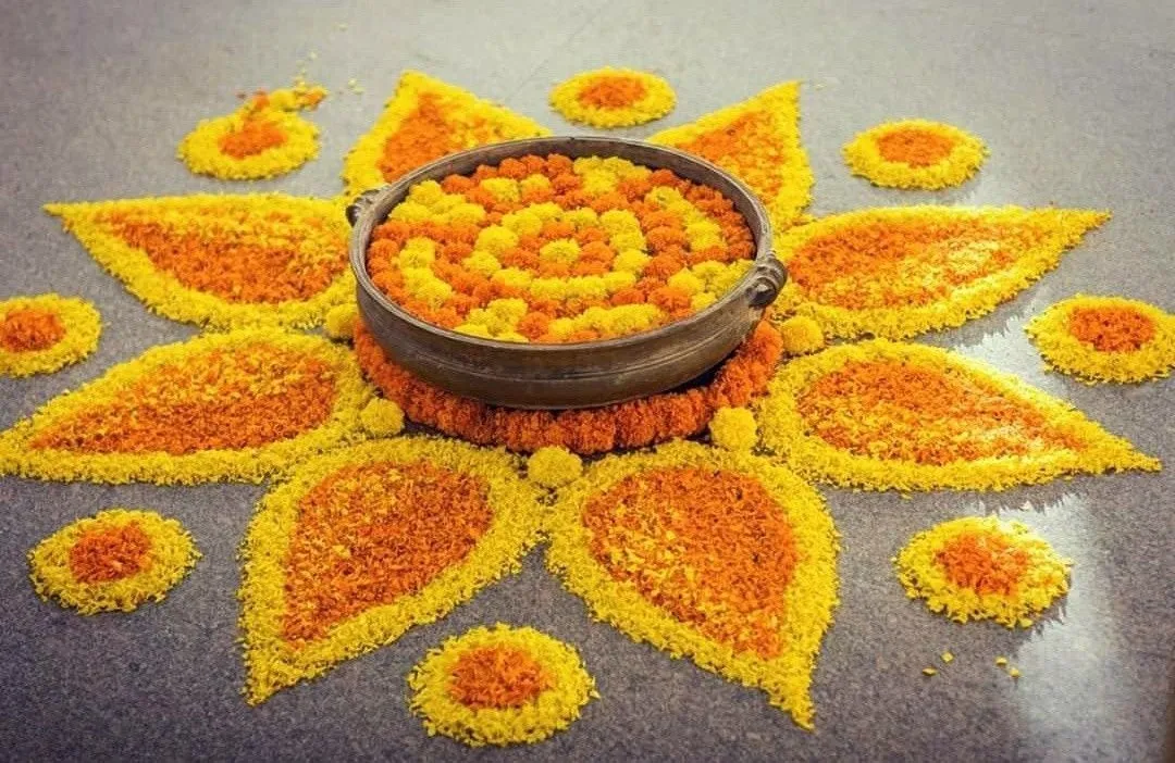 Onam pookolam with colourful flowers and Traditional vessel