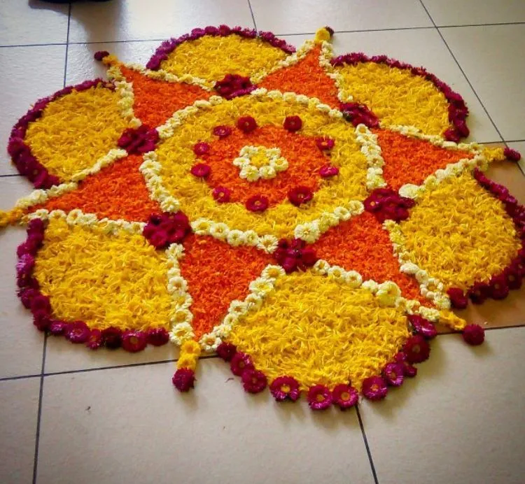 Onam pookolam with maroon flower border petal design image