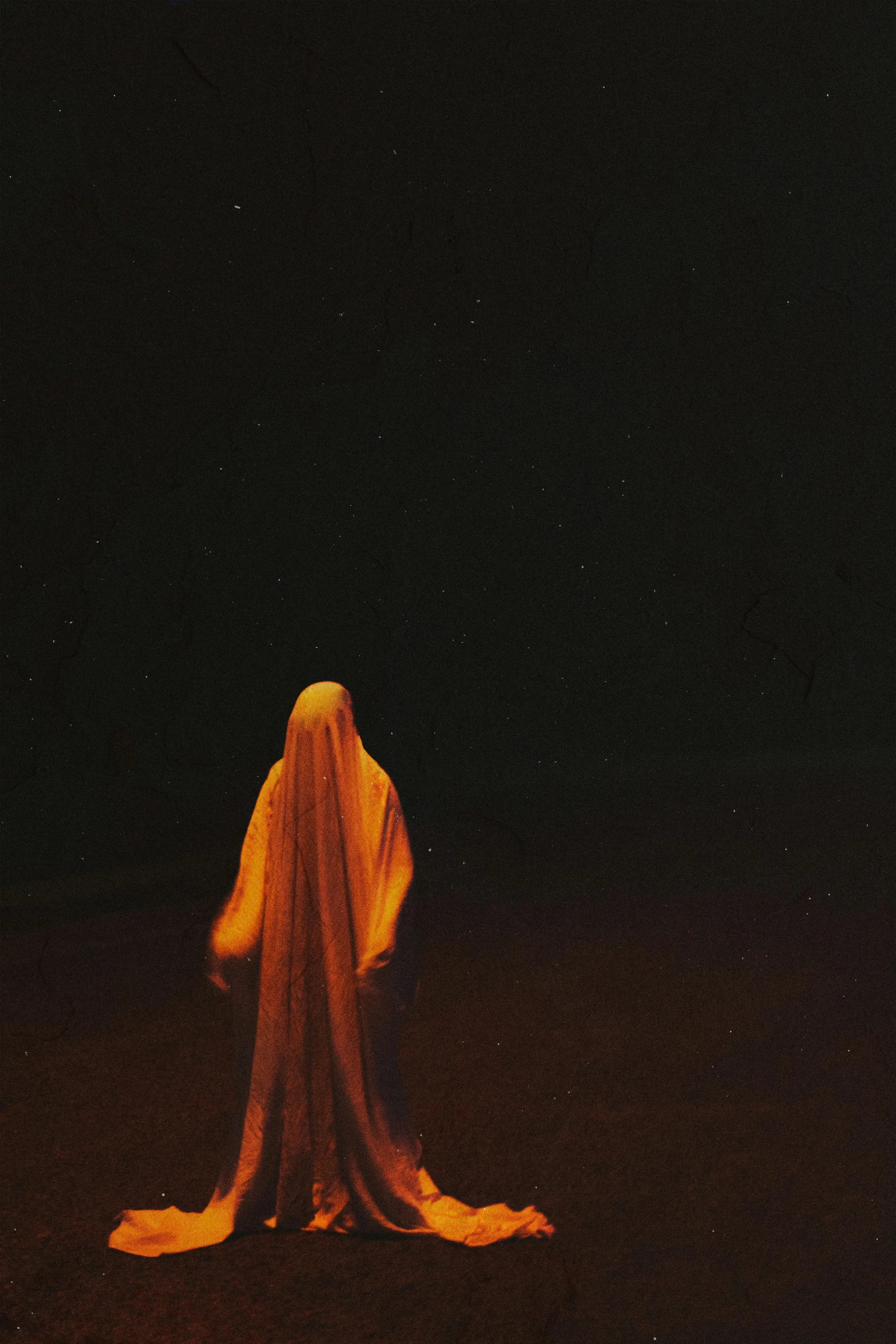 Orange Ghost Sheet Figure in Black Background Wallpaper