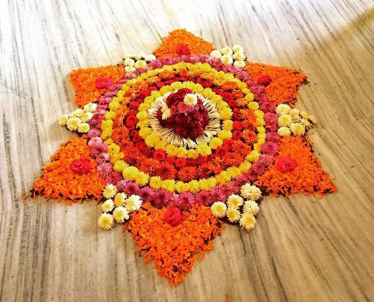 Orange petals with star shape pookolam Onam design images