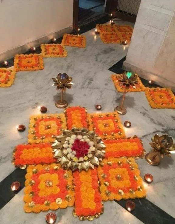 Orange square shape Pookolam with decoration lamps image