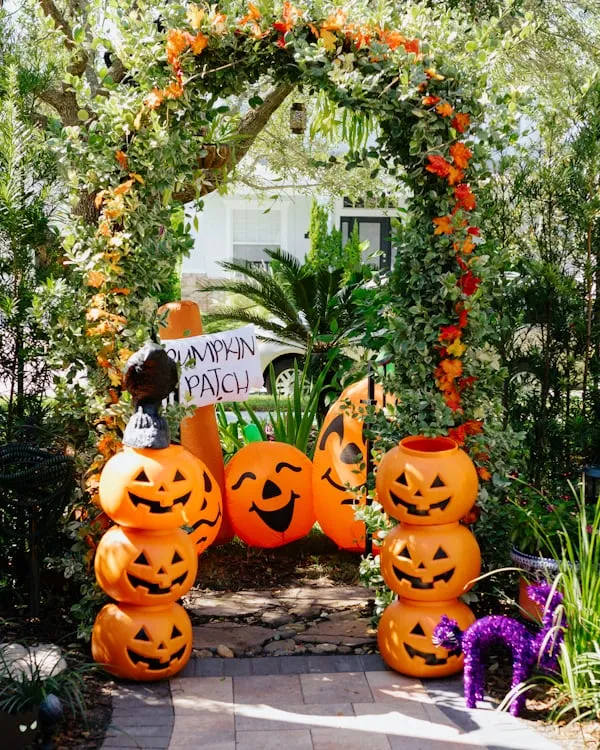 Outdoor Halloween Arch with Stacked Pumpkins and Faces