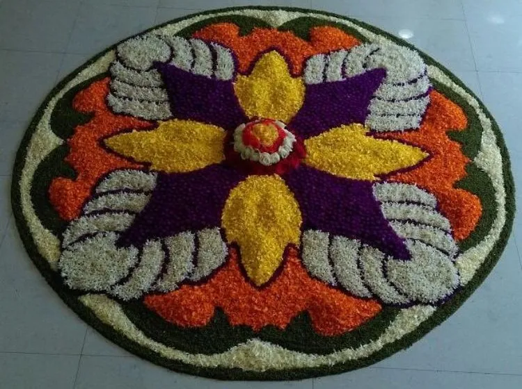 Oval rangoli design with purple yellow and Orange Petals
