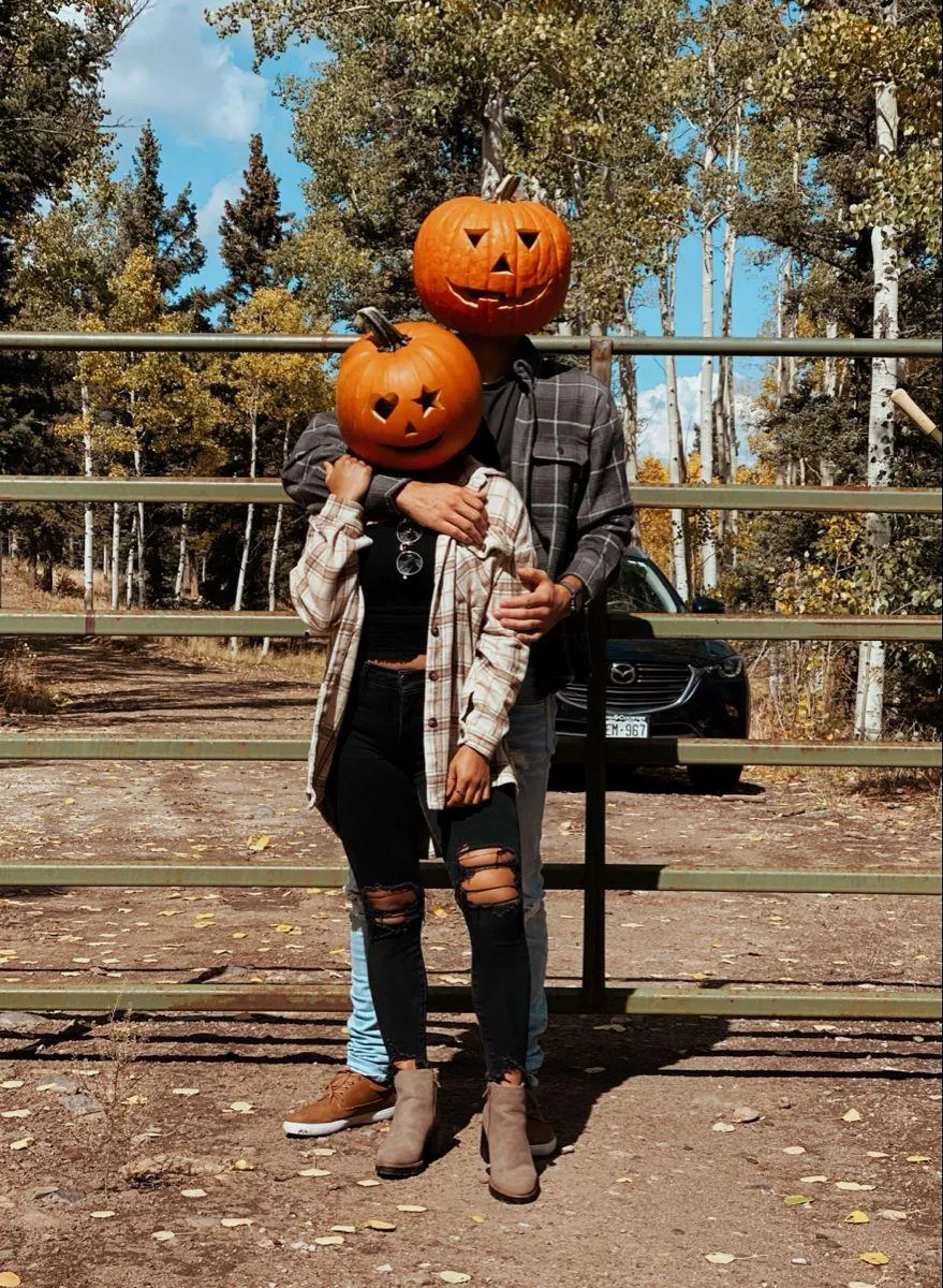 Parent and Child Wearing Pumpkin Masks at Playground