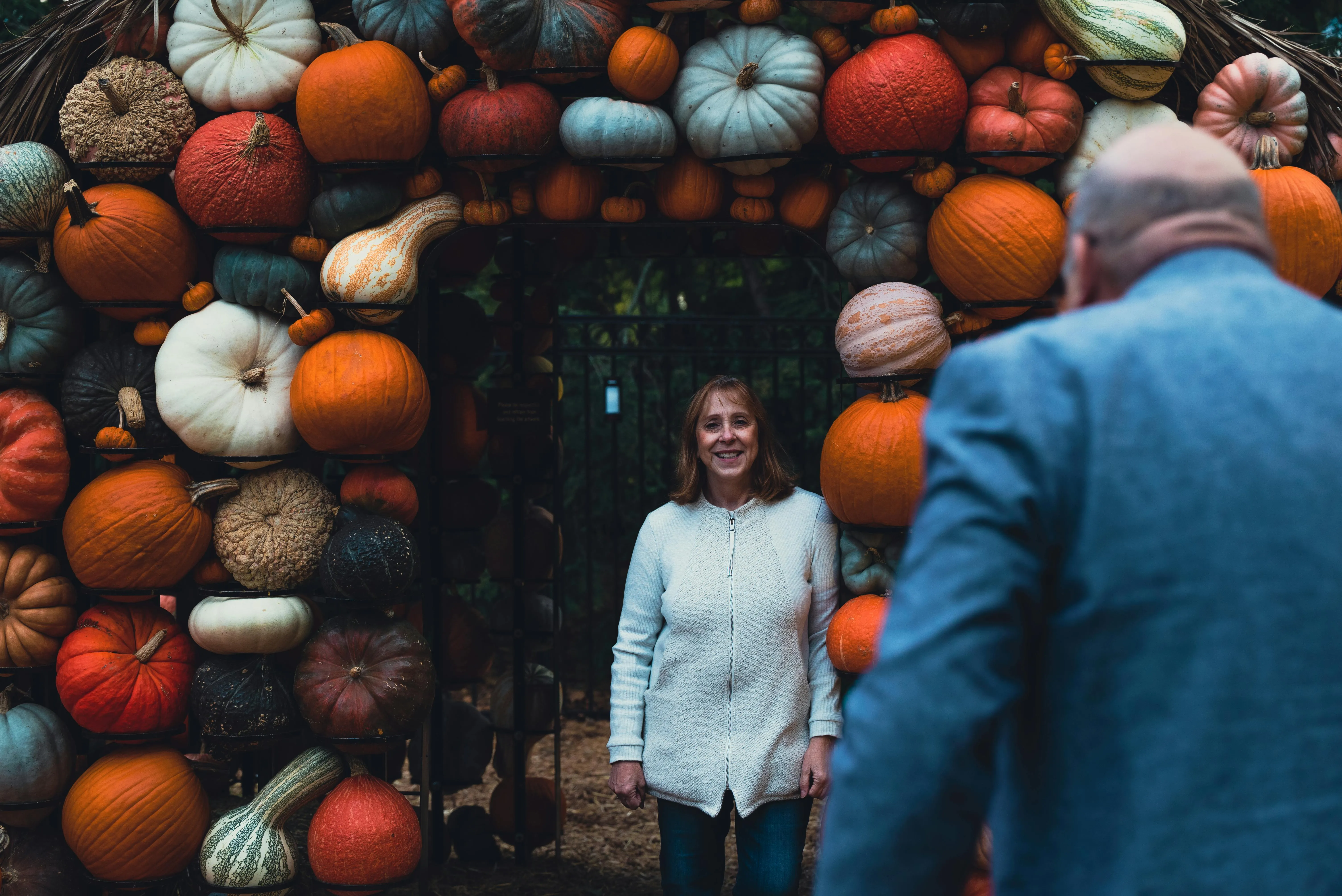 People at Colourful Pumpkin Arch at Halloween Festival HD