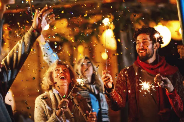 People Enjoying Fireworks Celebration Outdoors Wallpaper