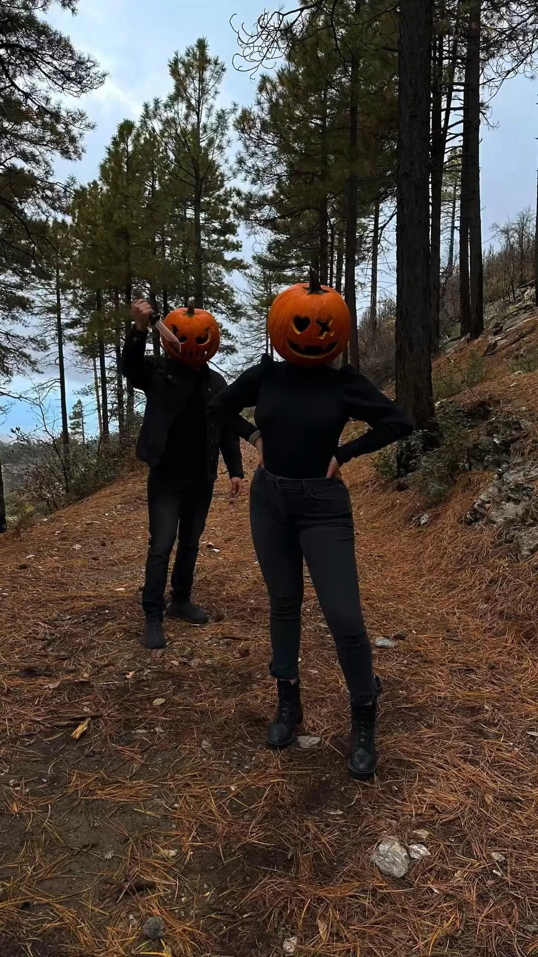 People in Pumpkin Masks Walking in Spooky Pine Woods
