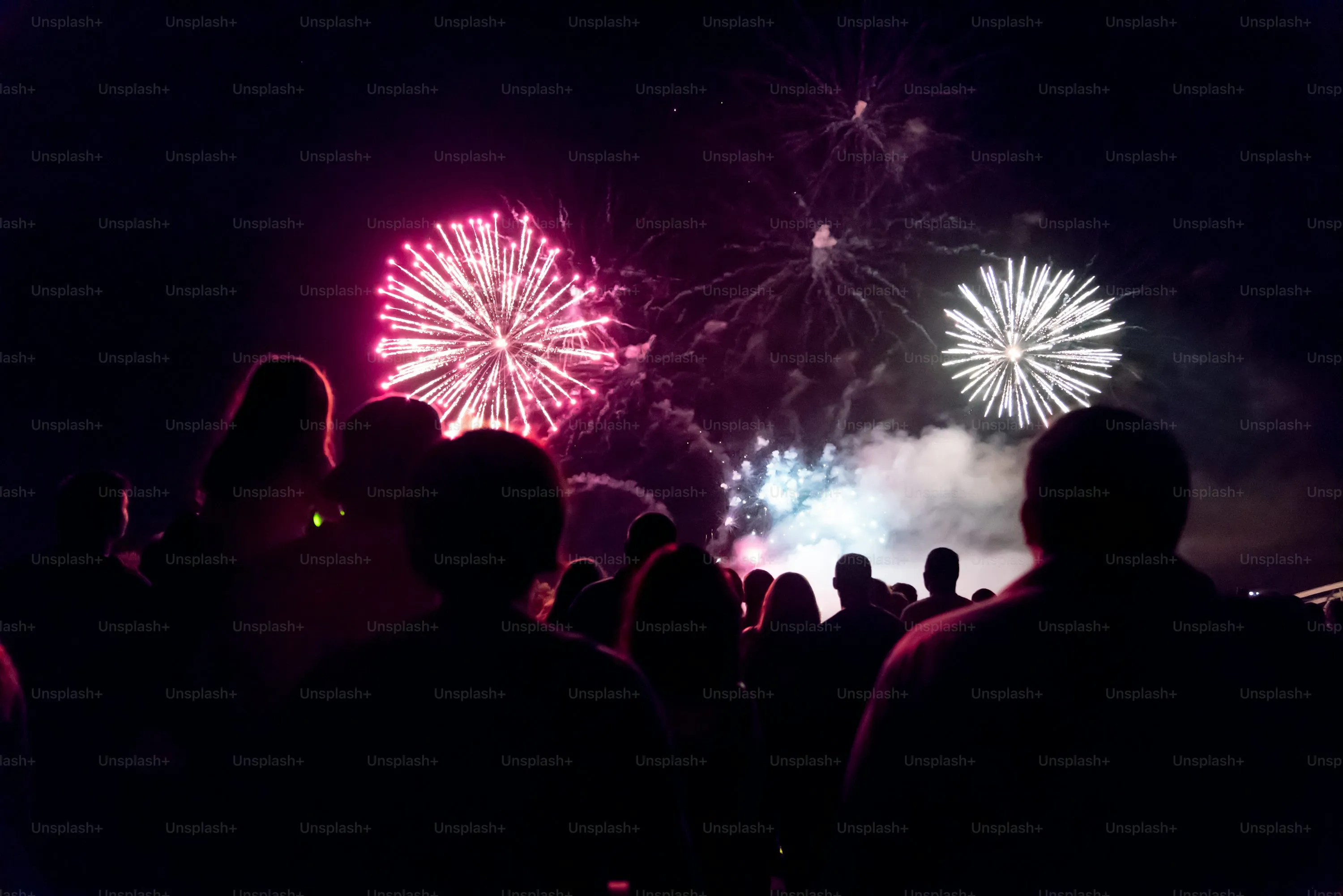 People Watching Fireworks With A Colorful Display image