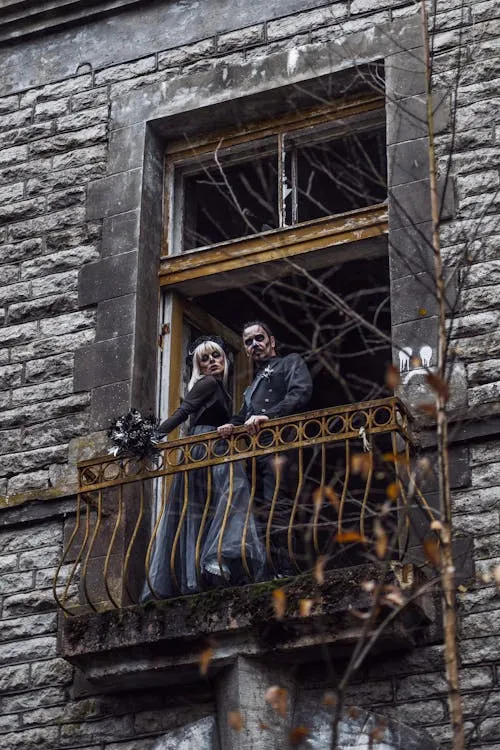 People Wearing Masks Standing on Old Balcony for Halloween