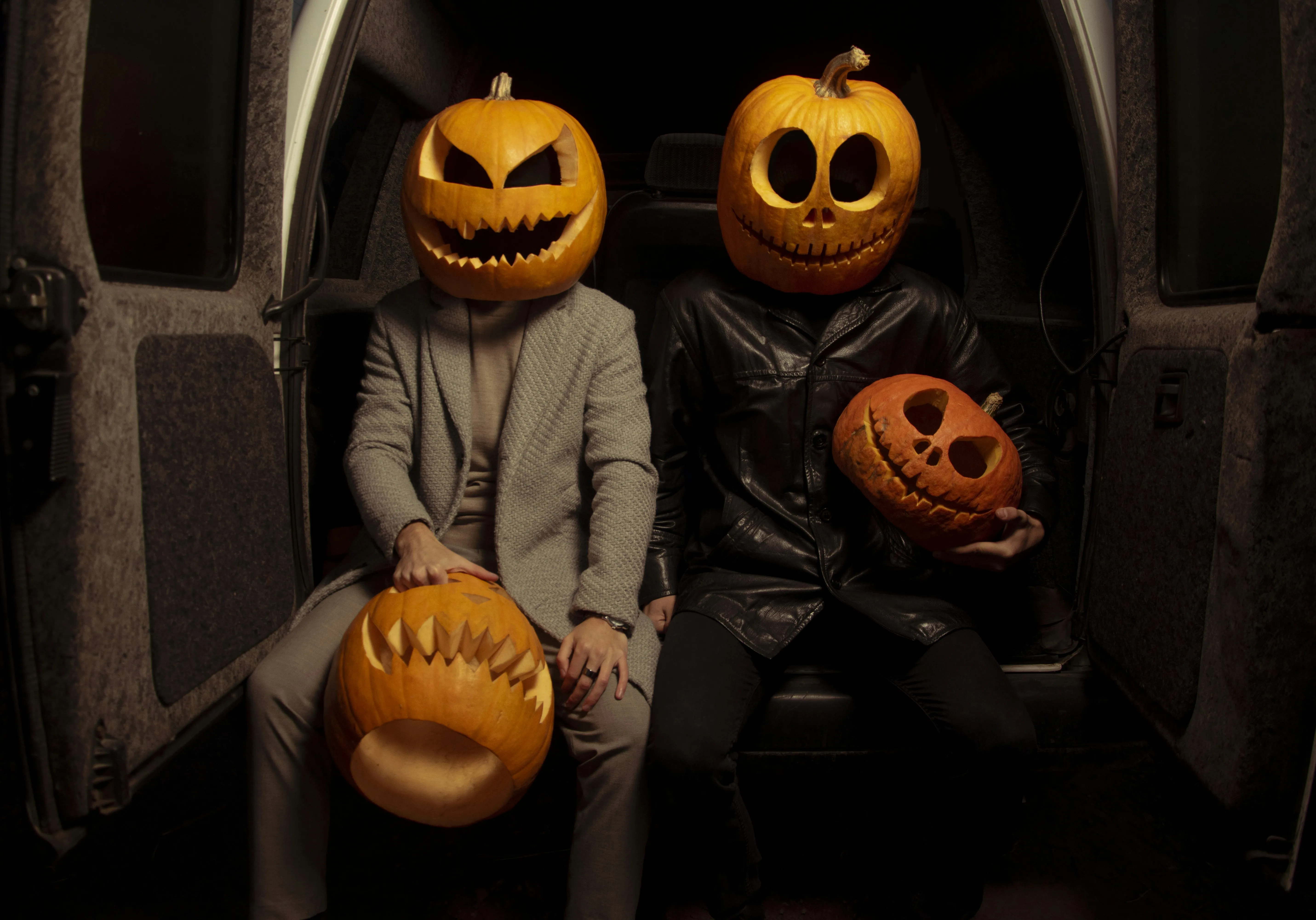 People Wearing Pumpkin Head Masks Indoors Wallpaper