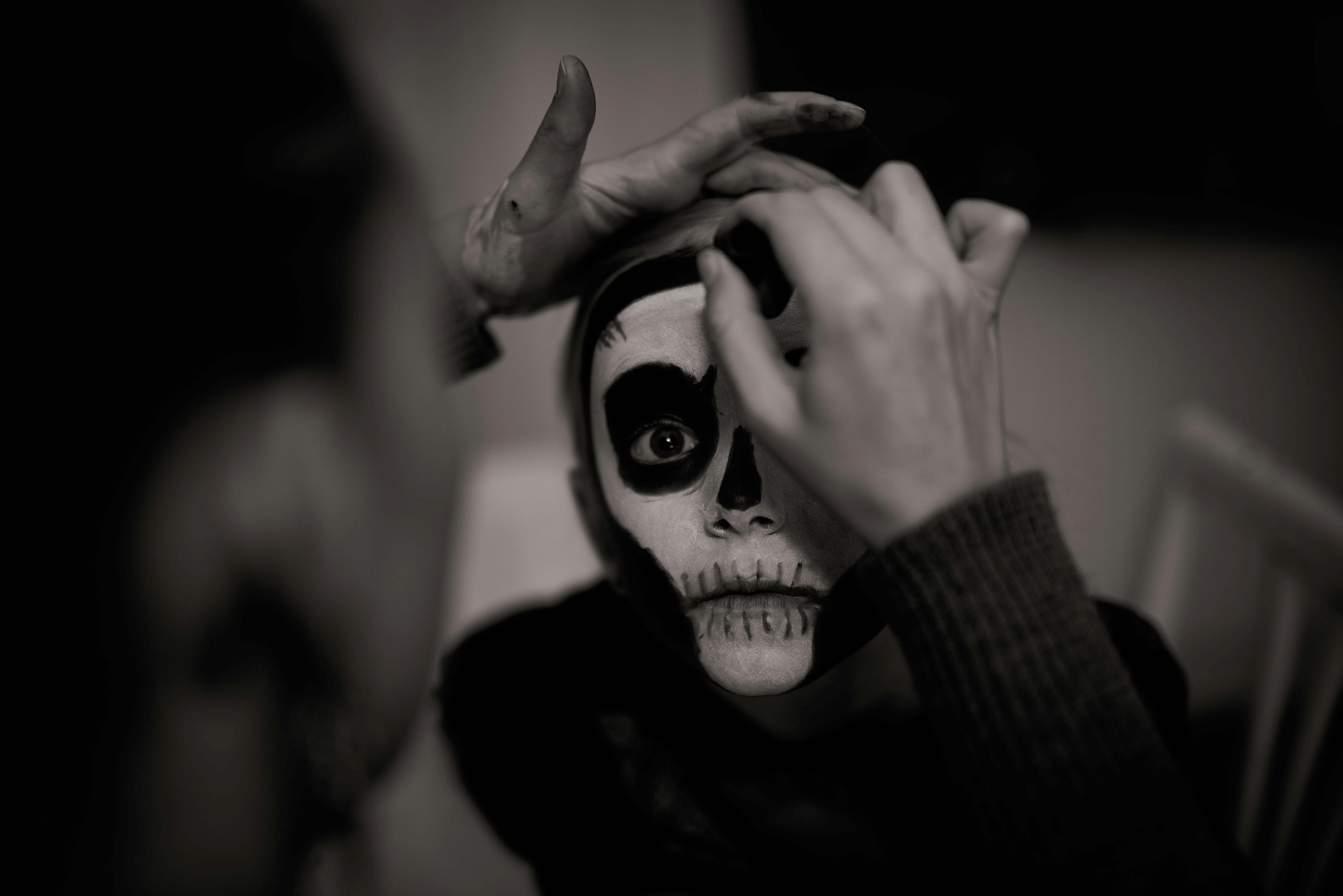Person Applying Skeleton Makeup for Halloween festival image
